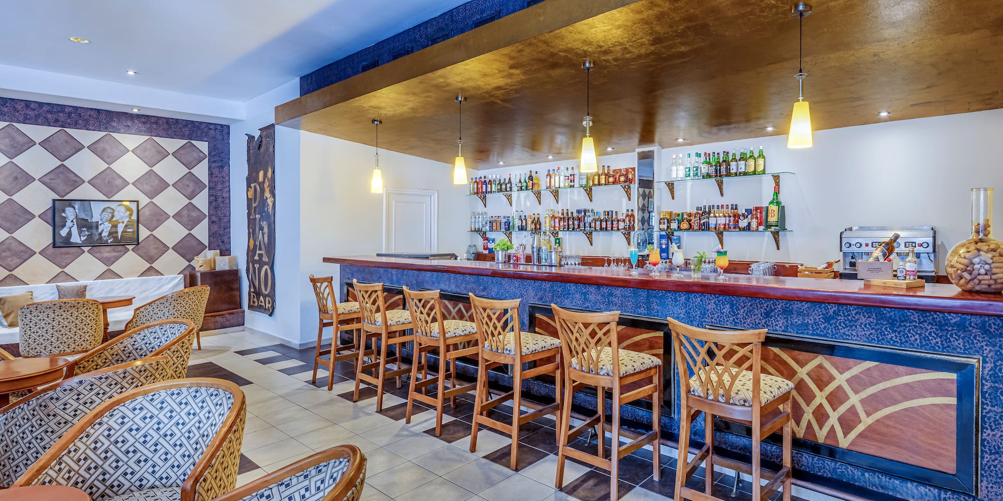 a bar with chairs and a counter