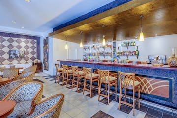 a bar with chairs and a counter