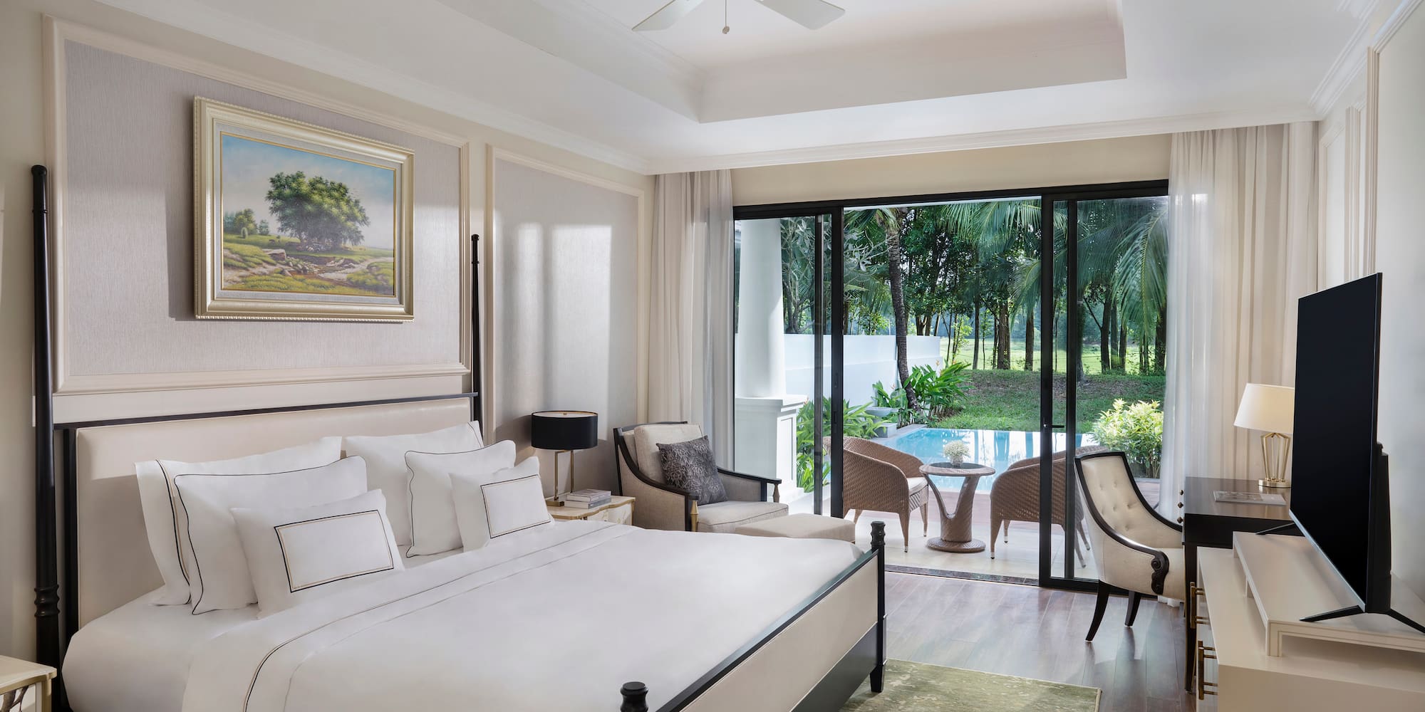 a bedroom with a large bed and a ceiling fan