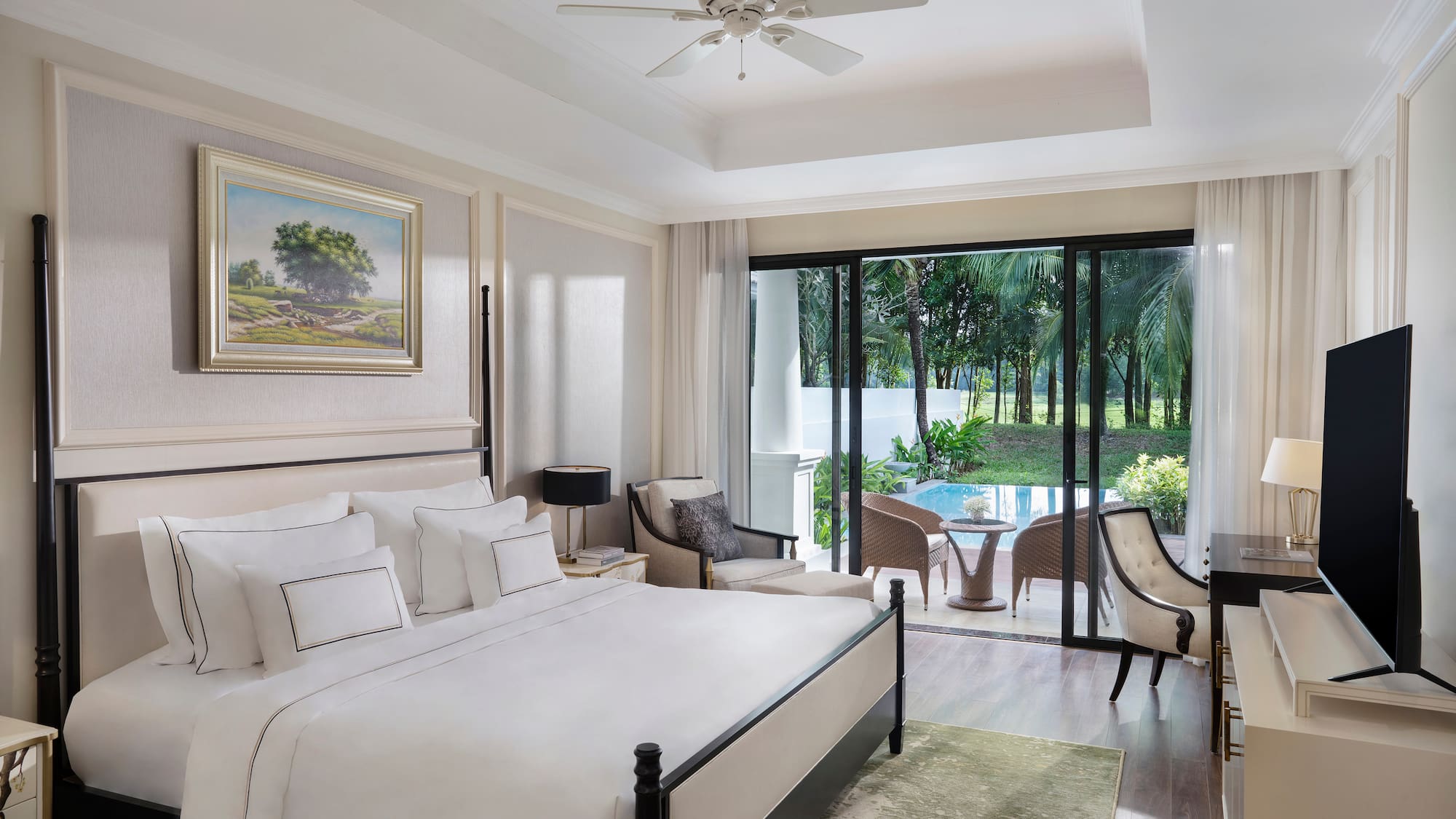 a bedroom with a large bed and a ceiling fan