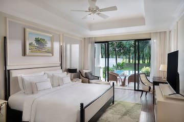 a bedroom with a large bed and a ceiling fan