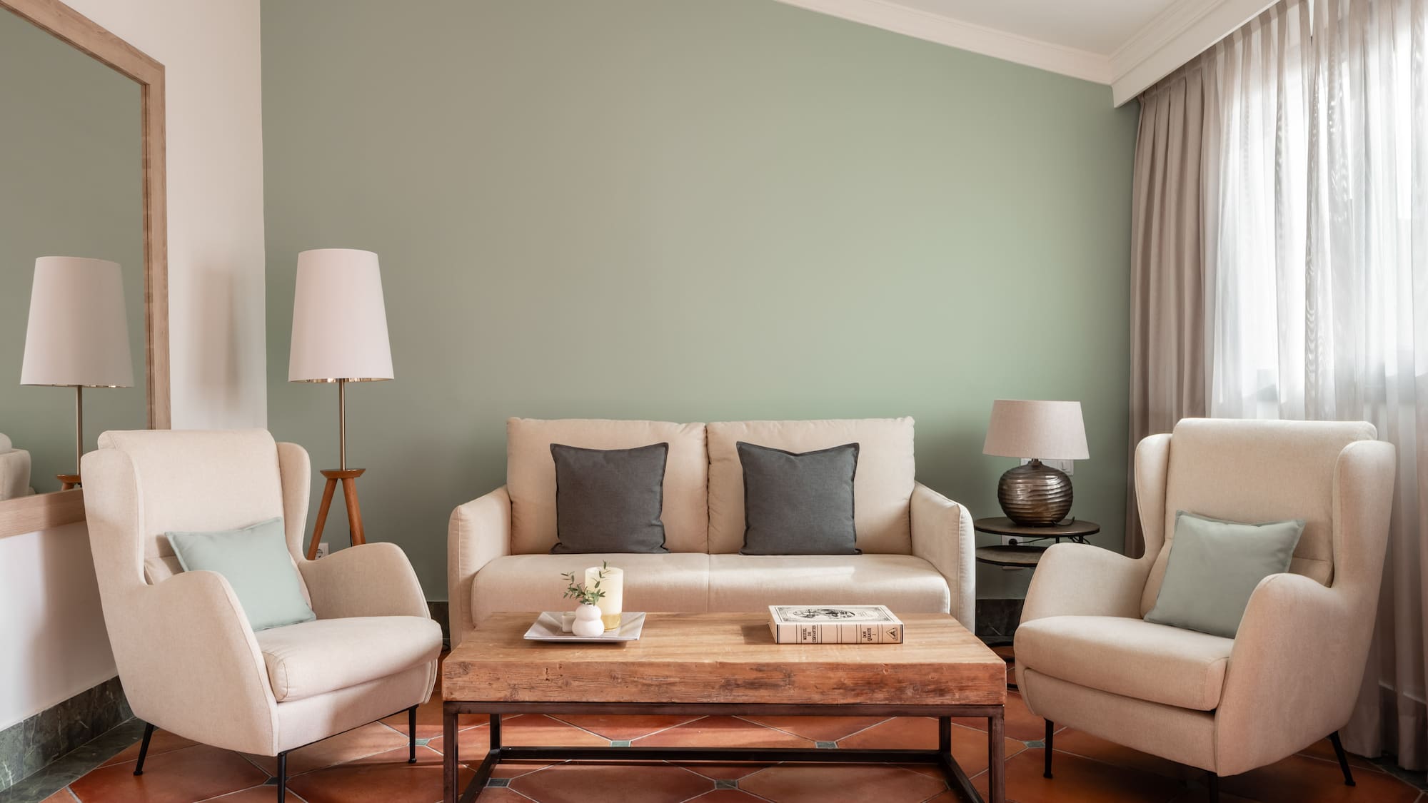 a living room with a couch and chairs