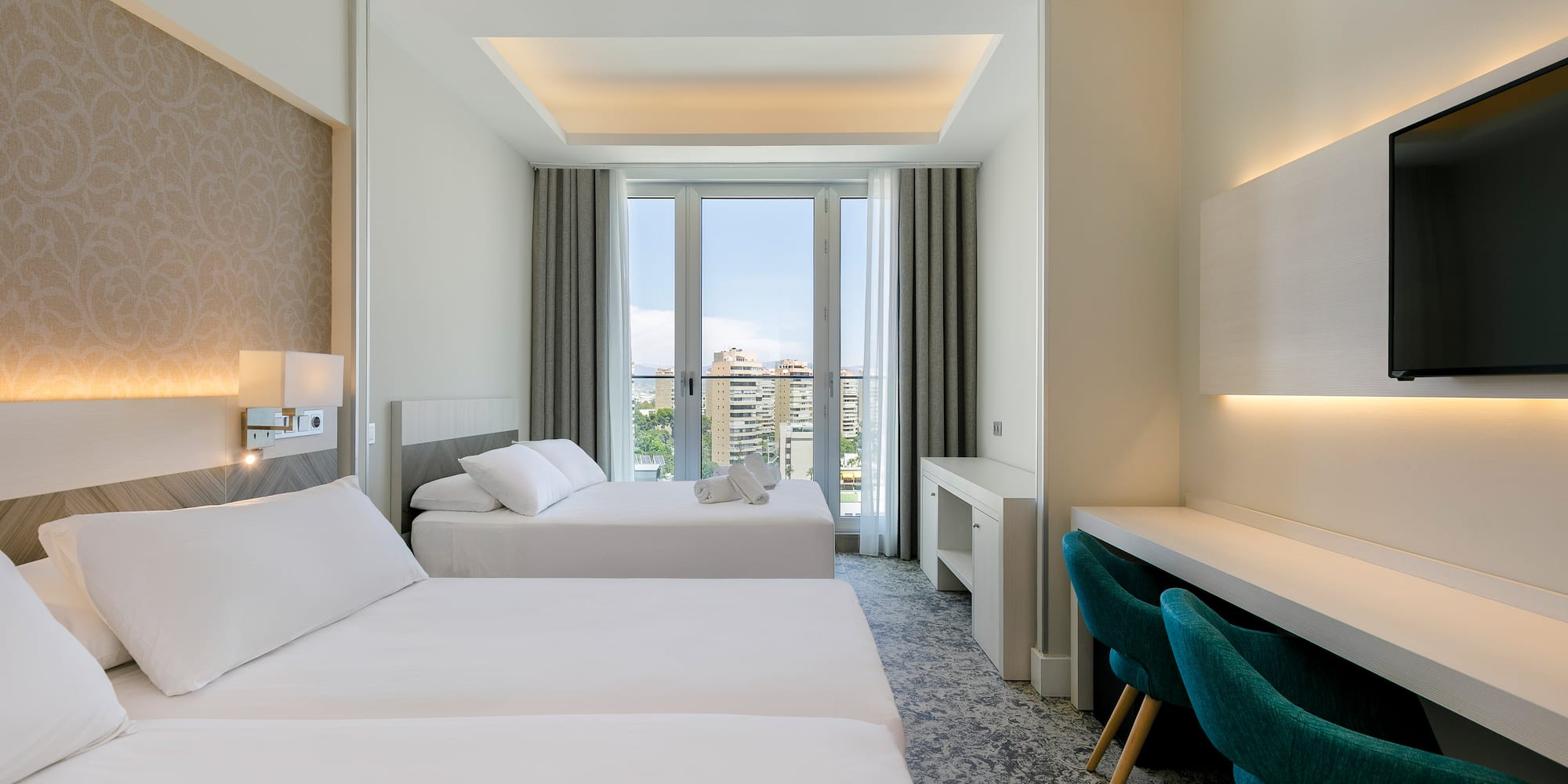 a room with two beds and a desk