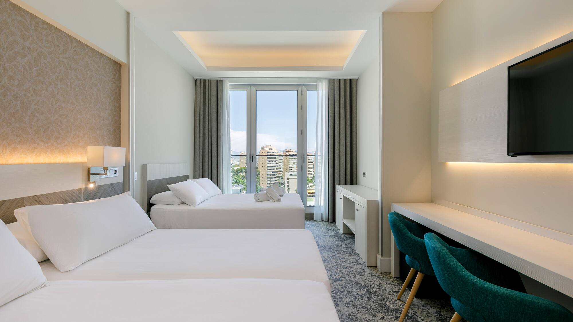 a room with two beds and a desk