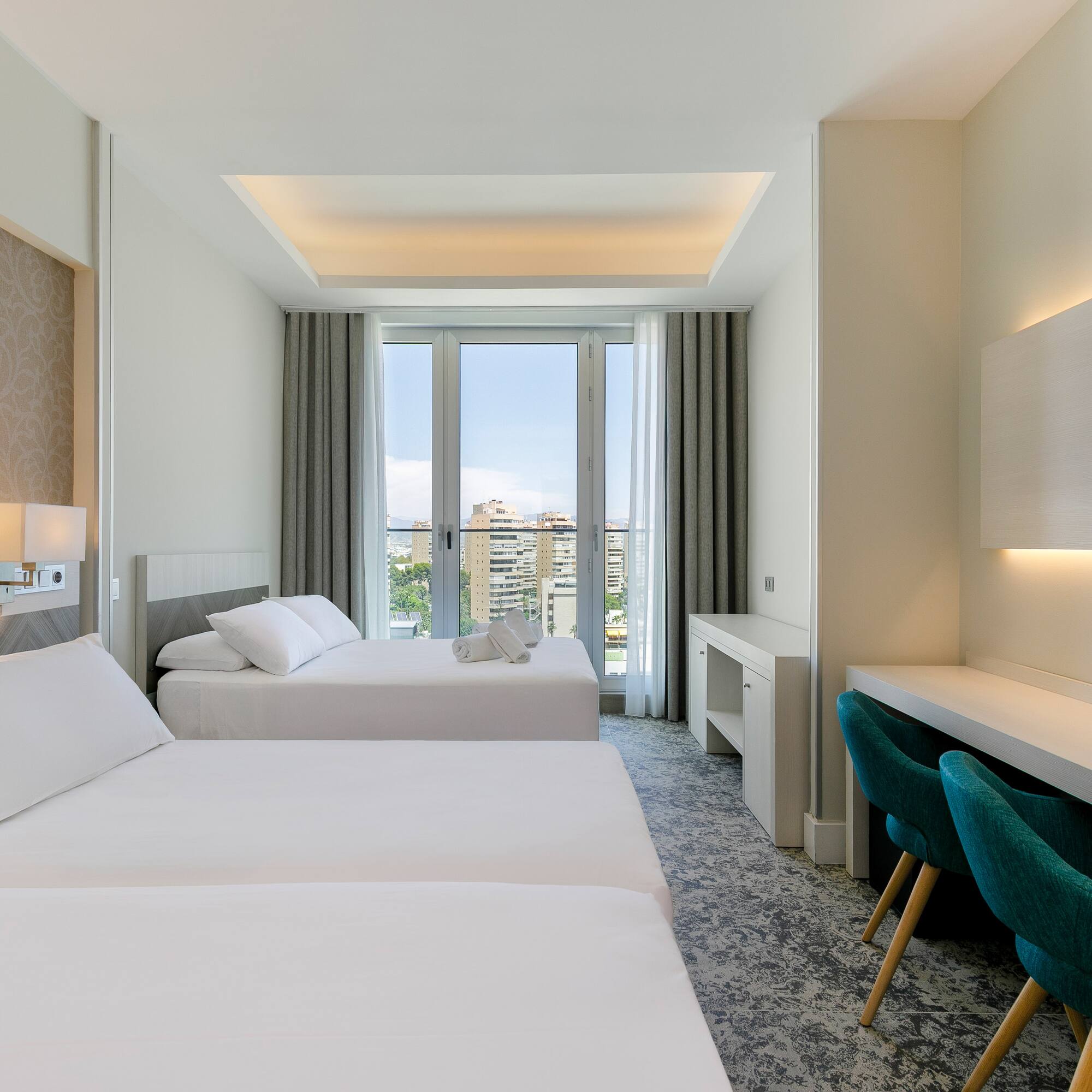 a room with two beds and a desk