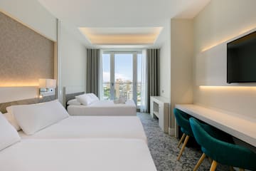 a room with two beds and a desk