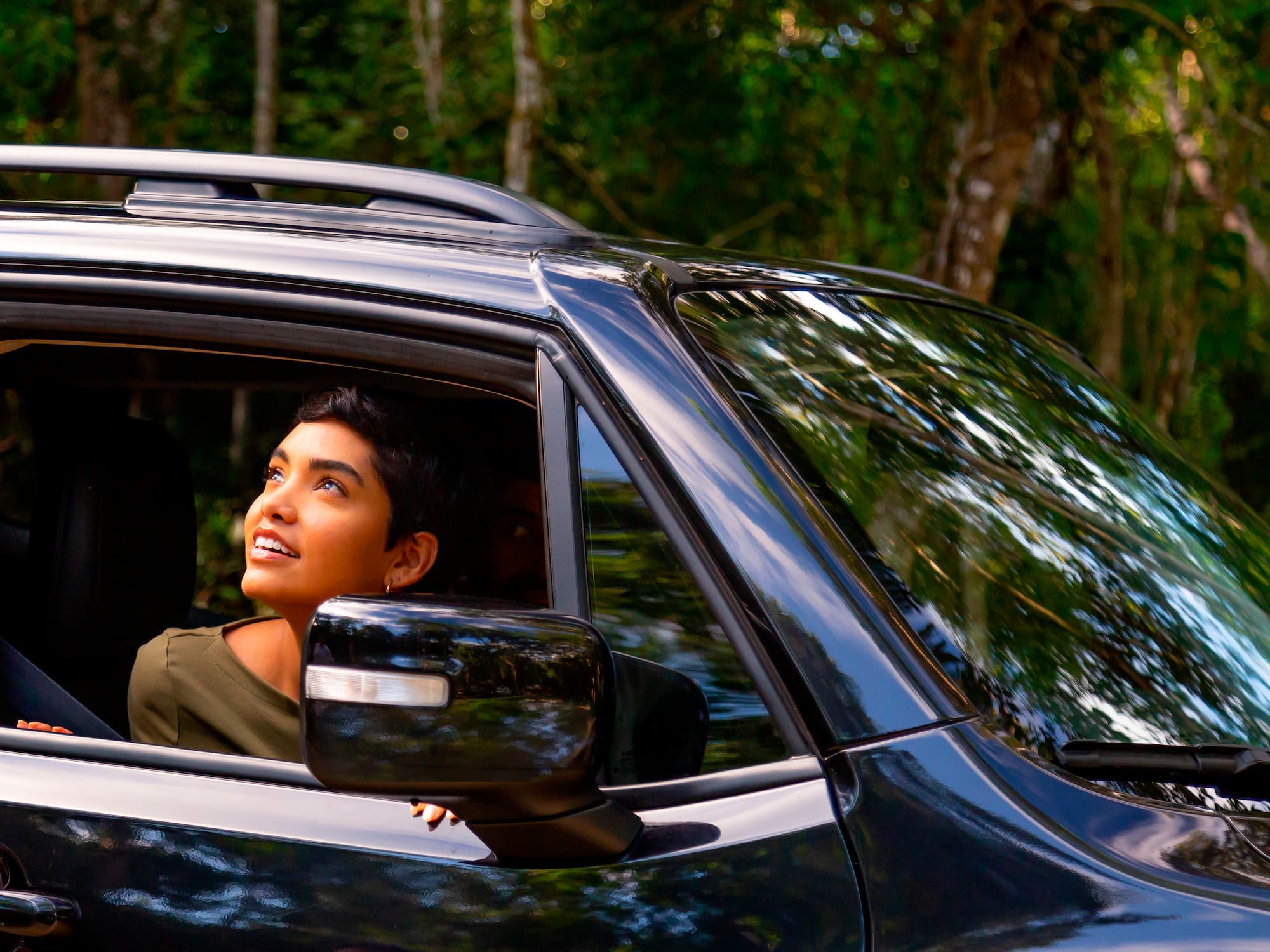 a woman looking out of a car window