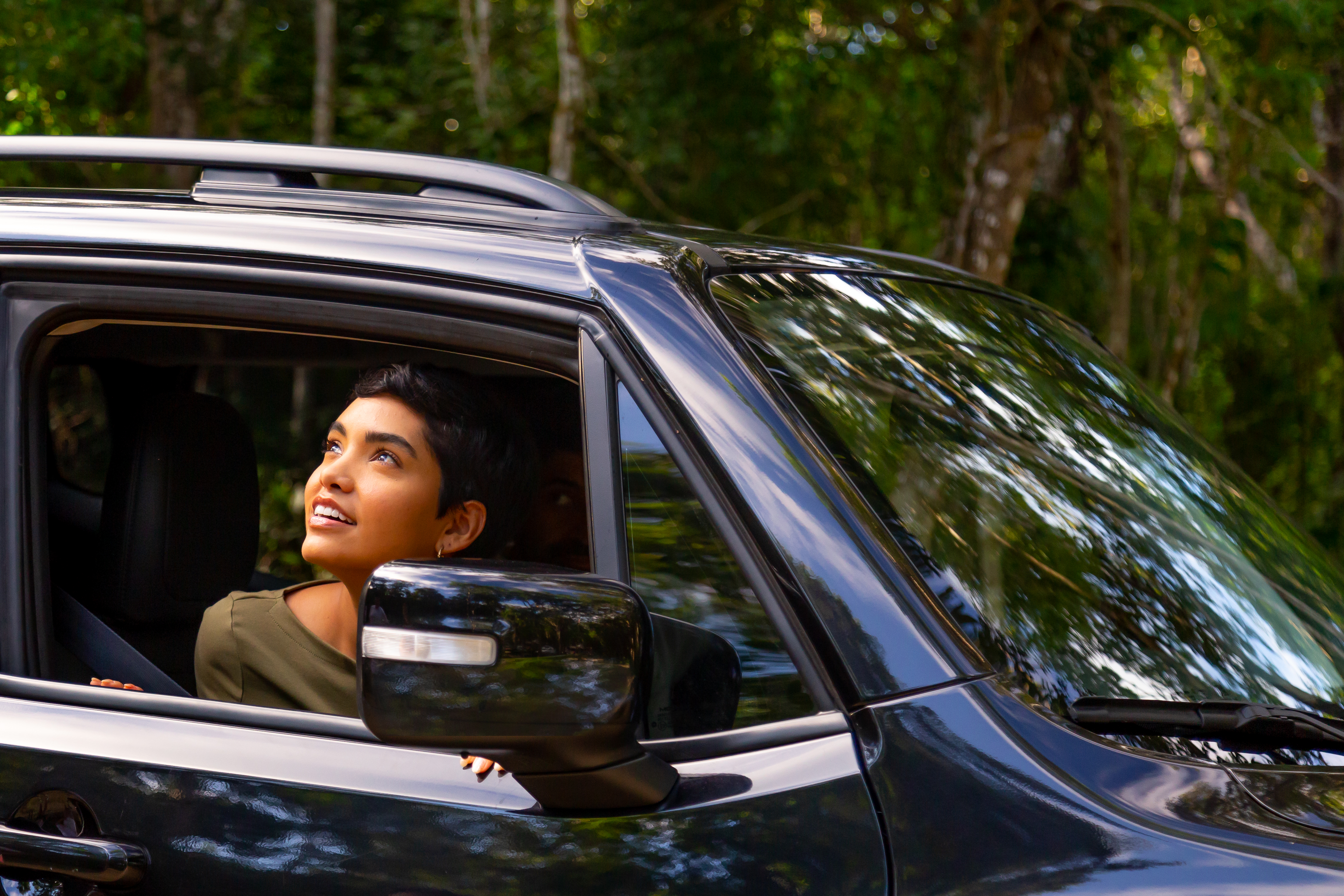 a woman looking out of a car window