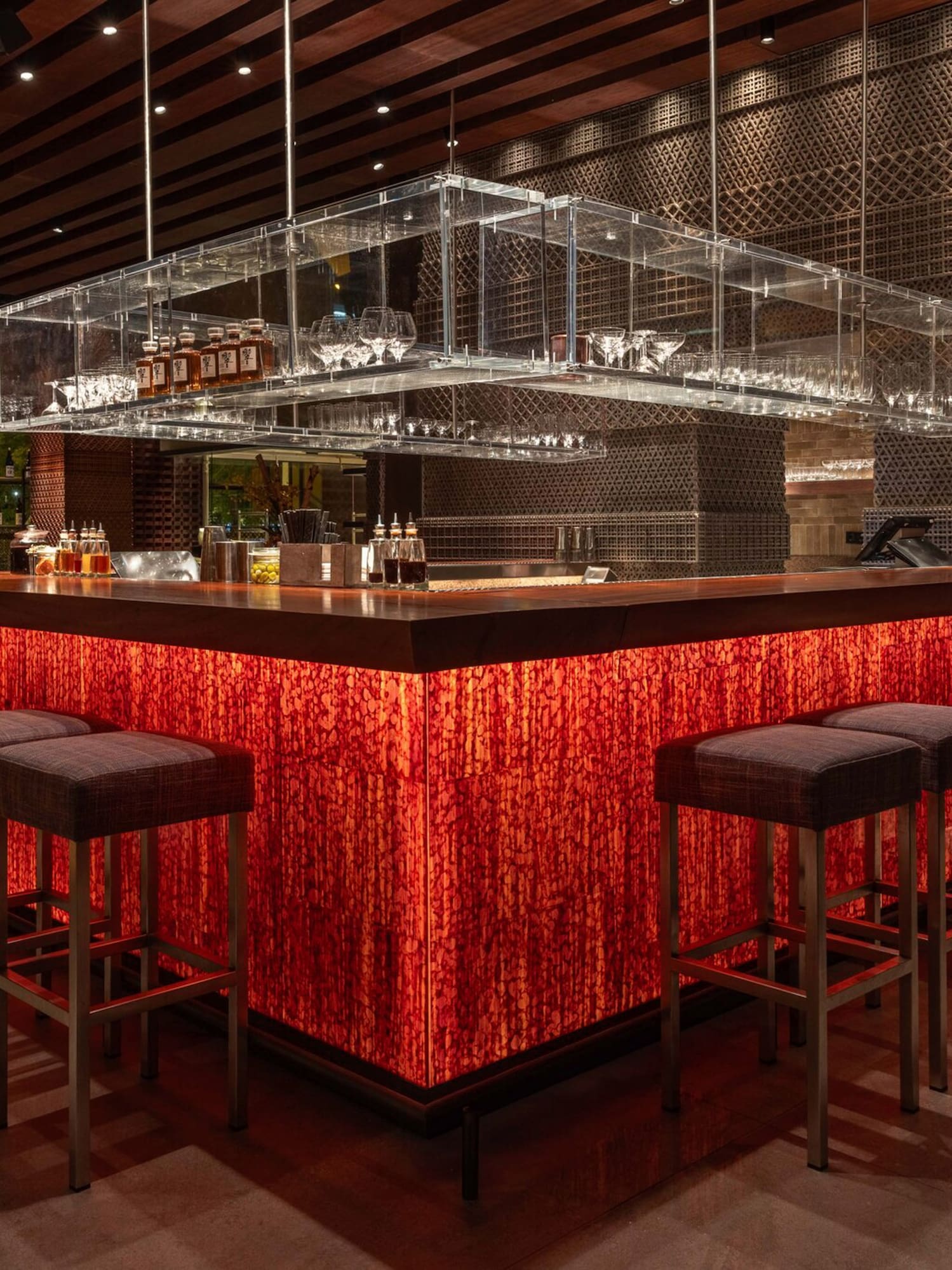 a bar with a red counter and chairs