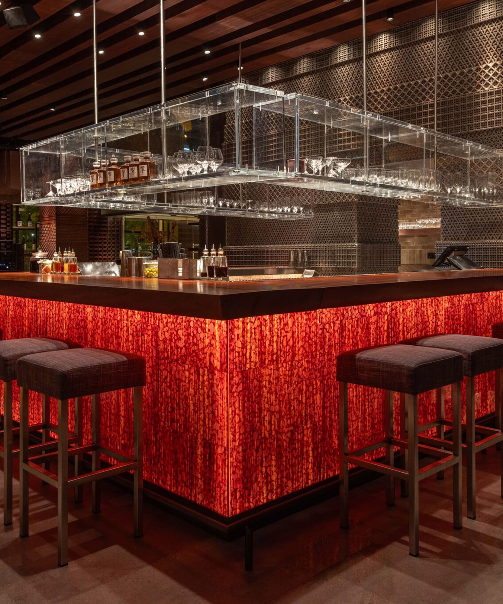 a bar with a red counter and chairs
