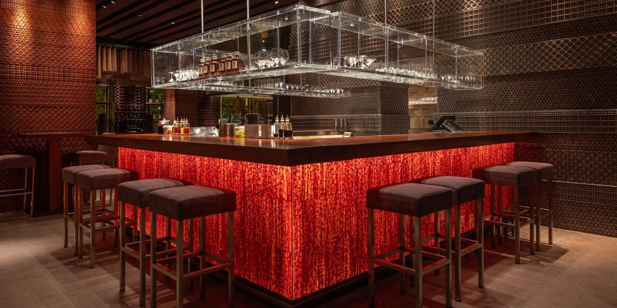 a bar with a red counter and chairs