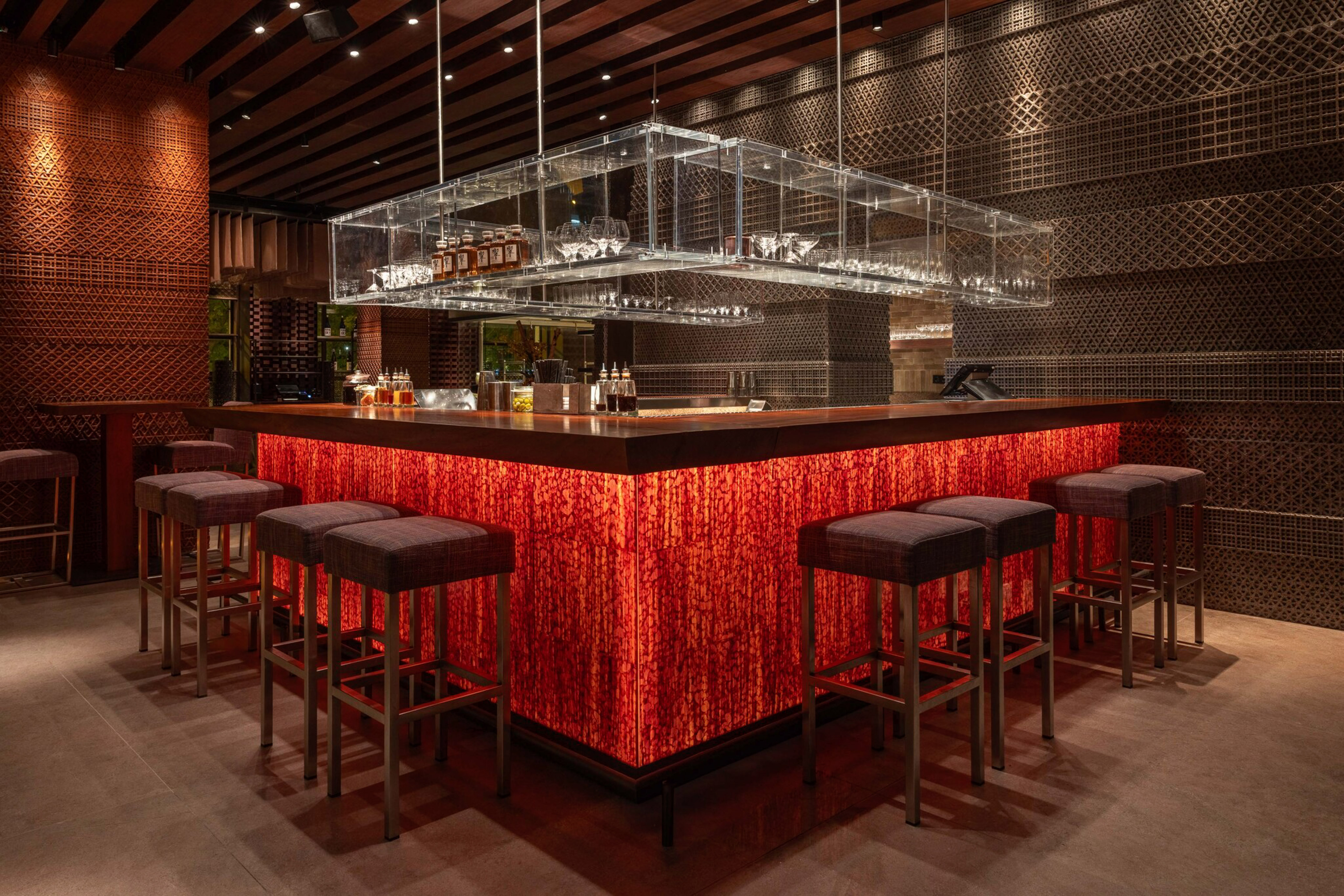 a bar with a red counter and chairs