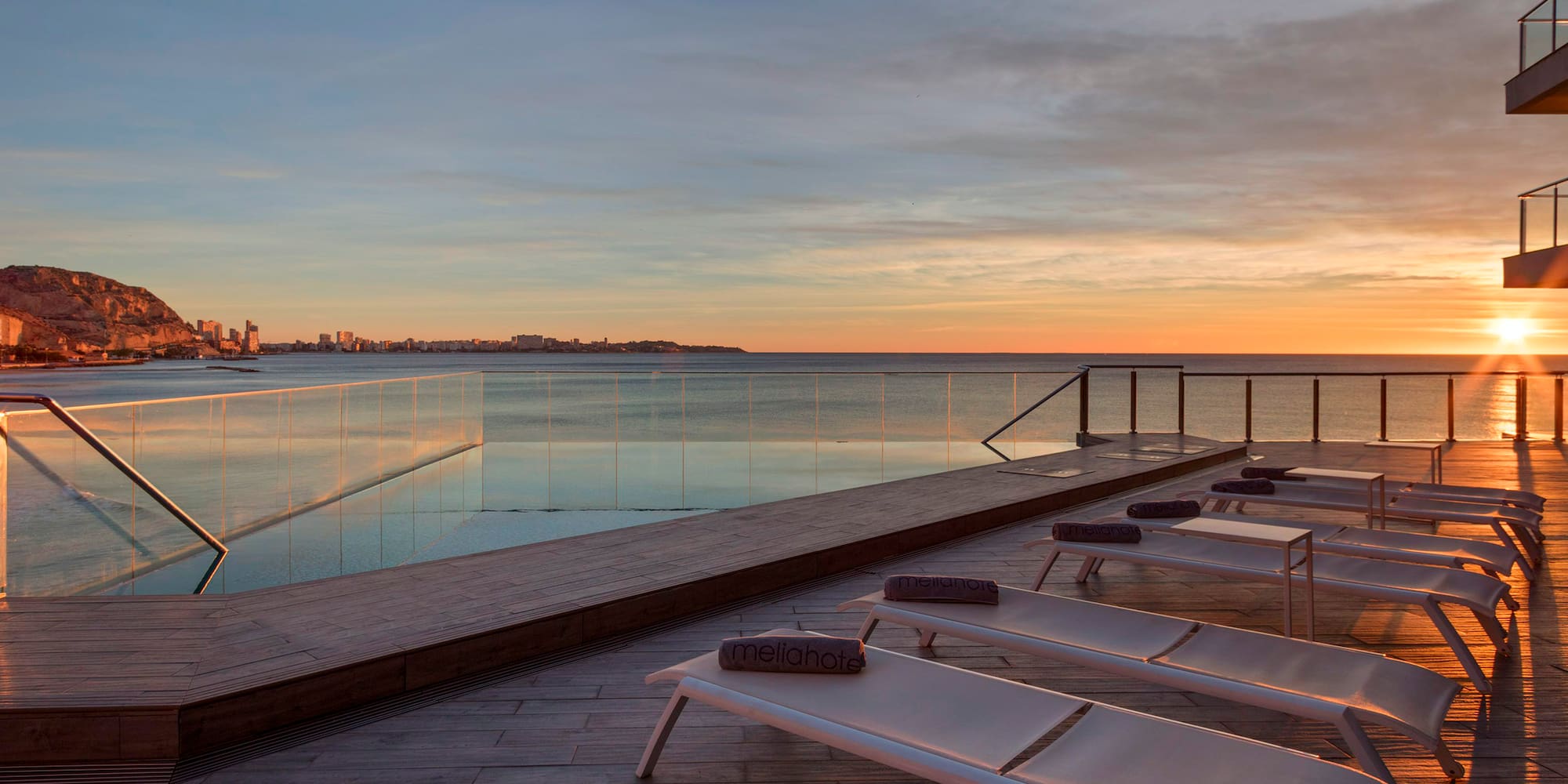 a pool with a deck and chairs on it