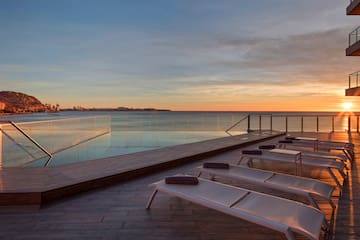 a pool with a deck and chairs on it