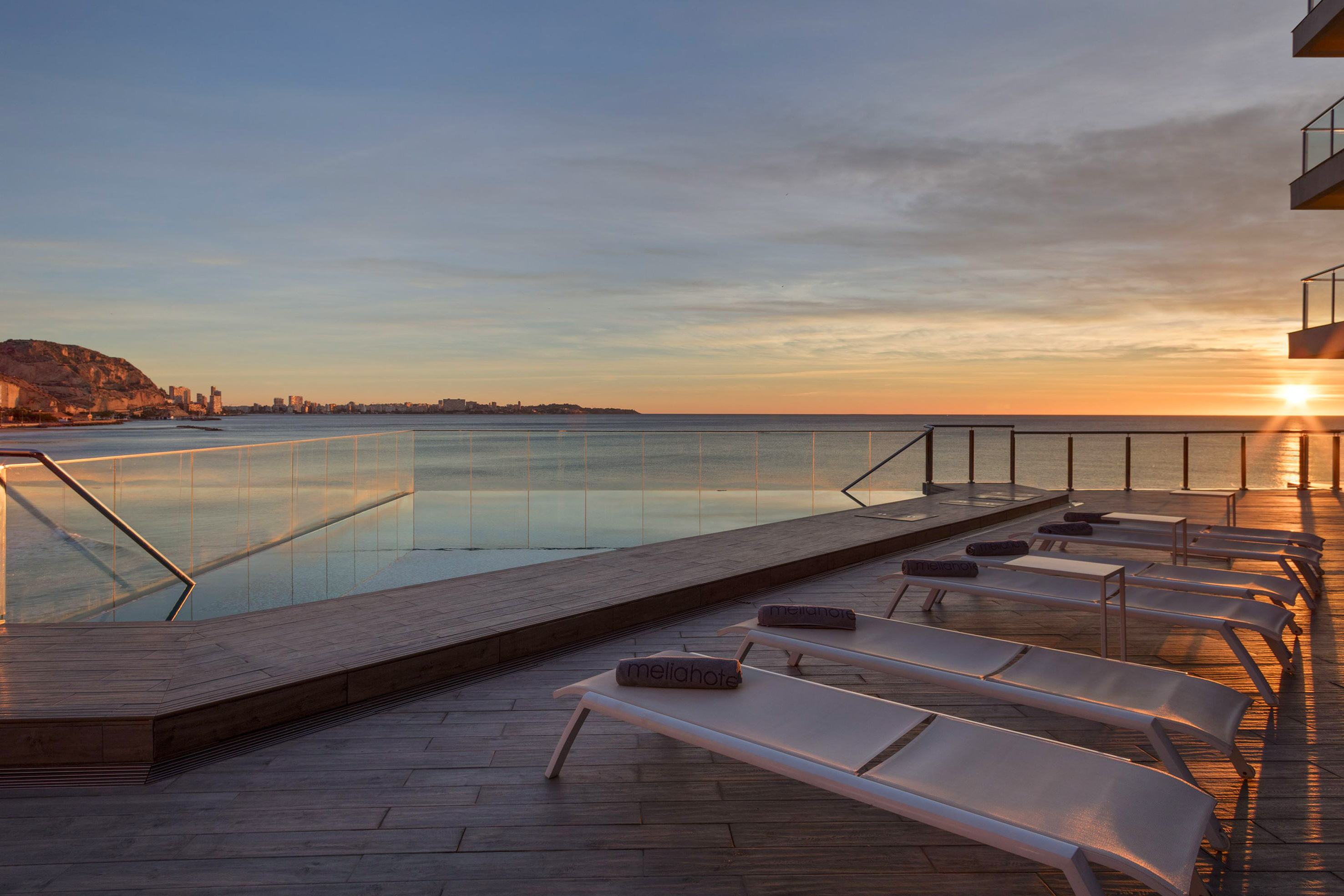 a pool with a deck and chairs on it