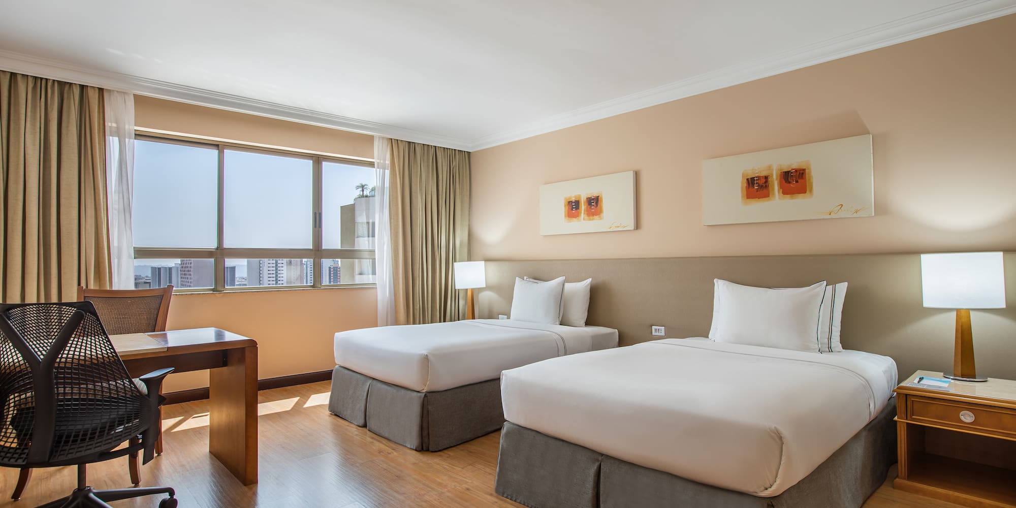 a room with two beds and a desk