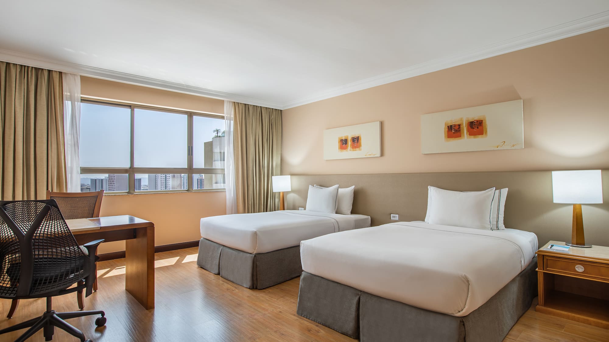 a room with two beds and a desk