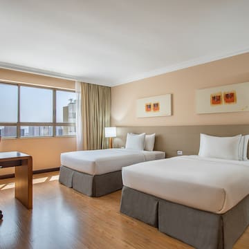 a room with two beds and a desk