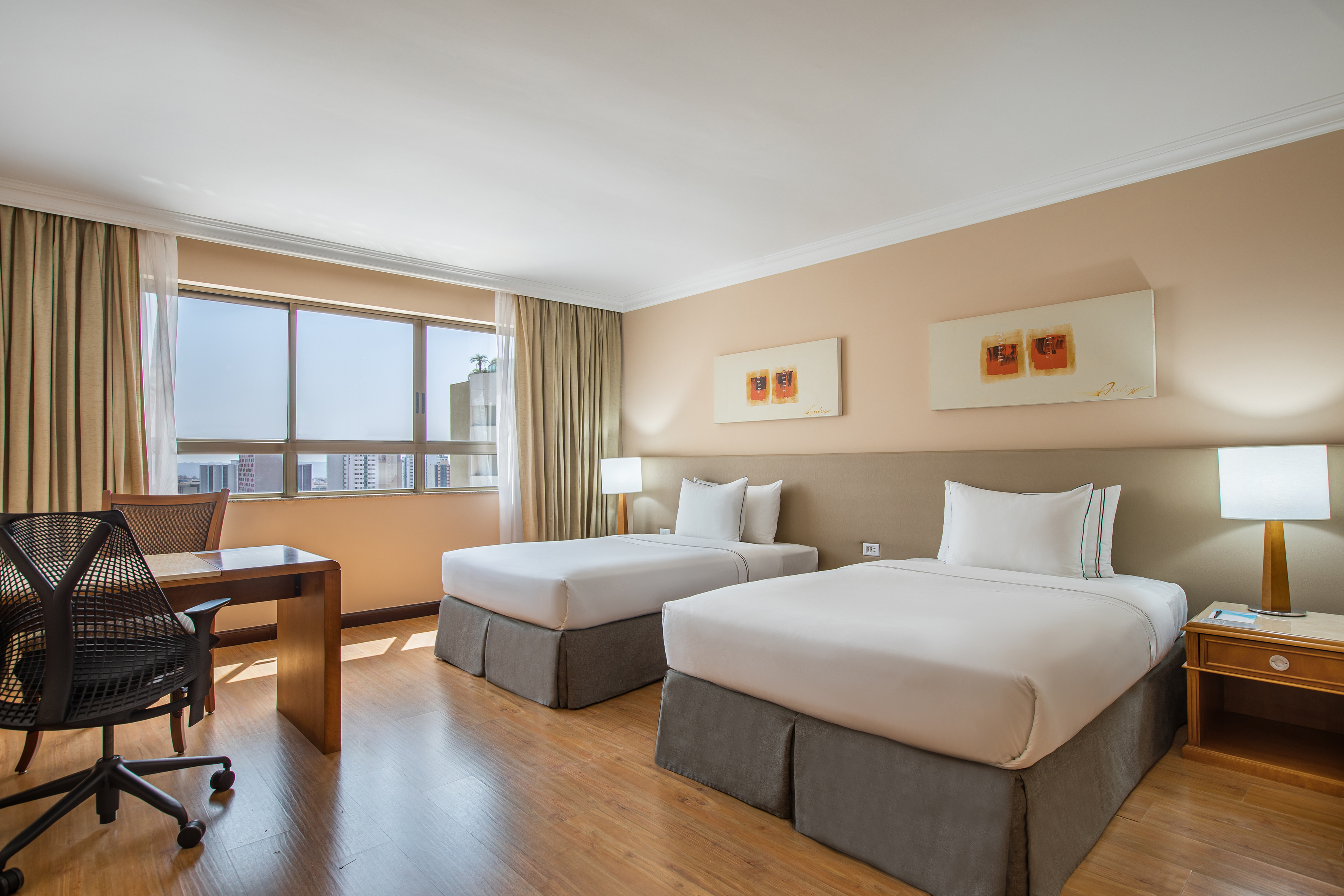 a room with two beds and a desk