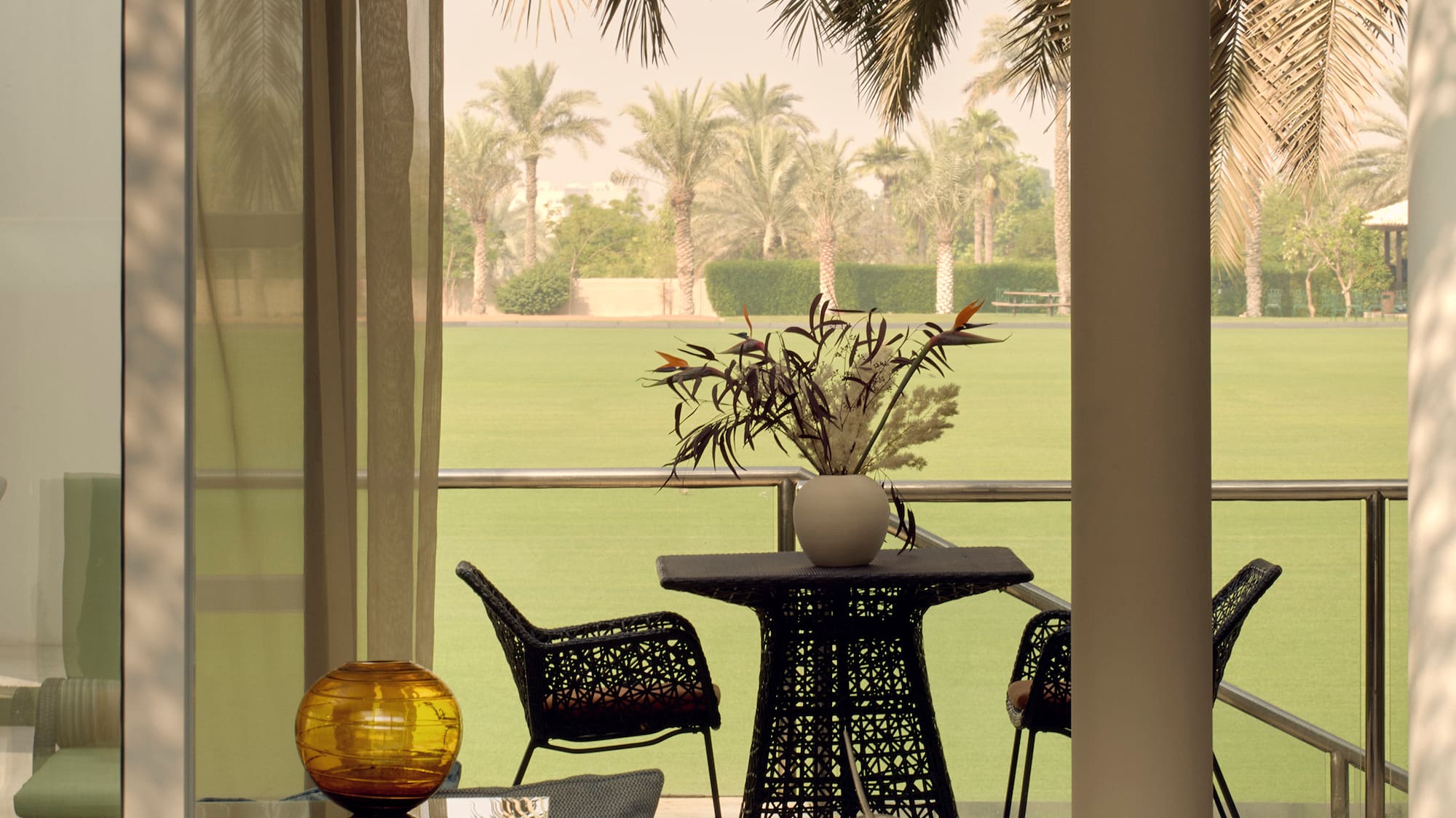 a room with a table and chairs and a lawn