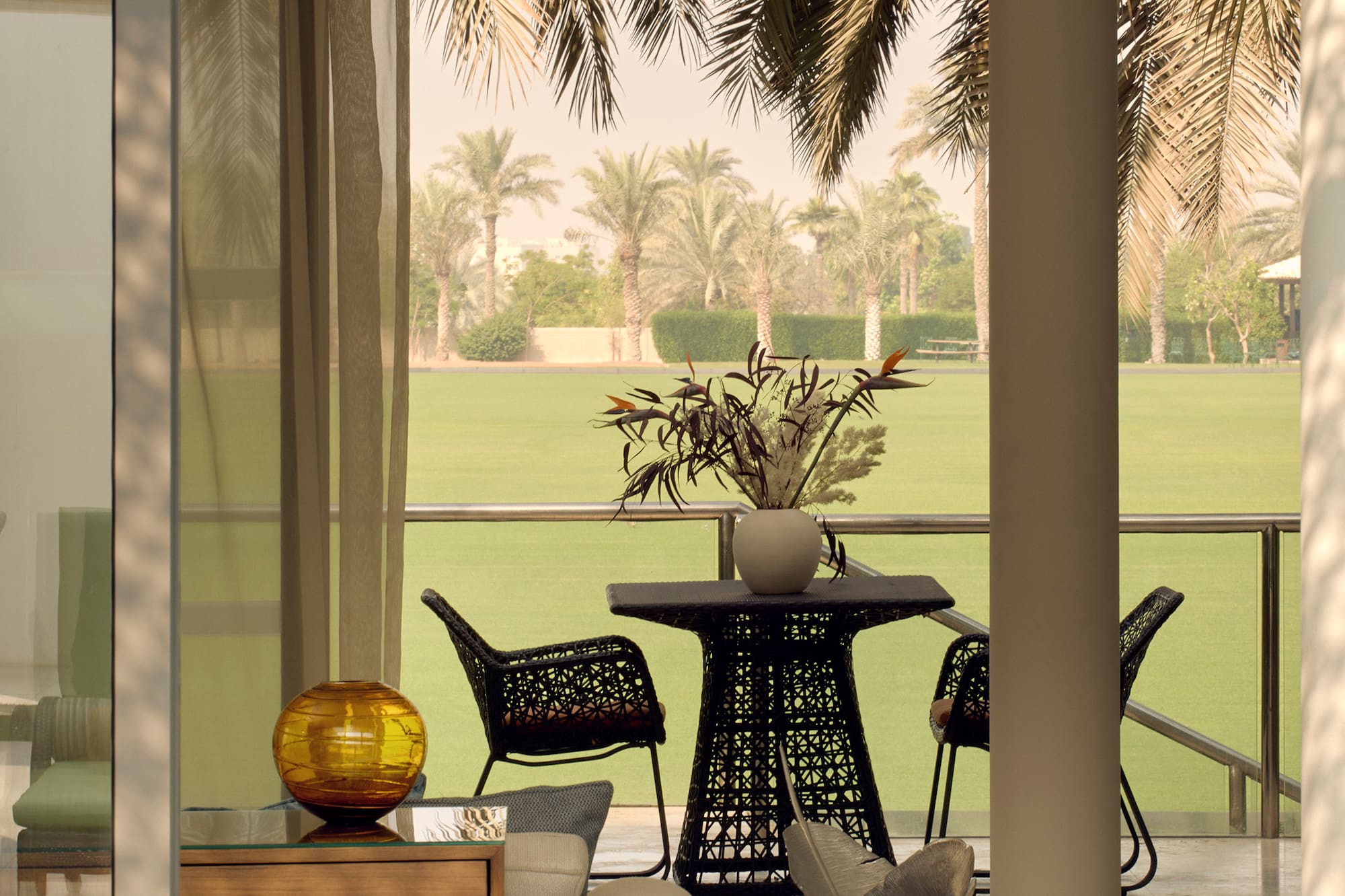 a room with a table and chairs and a lawn