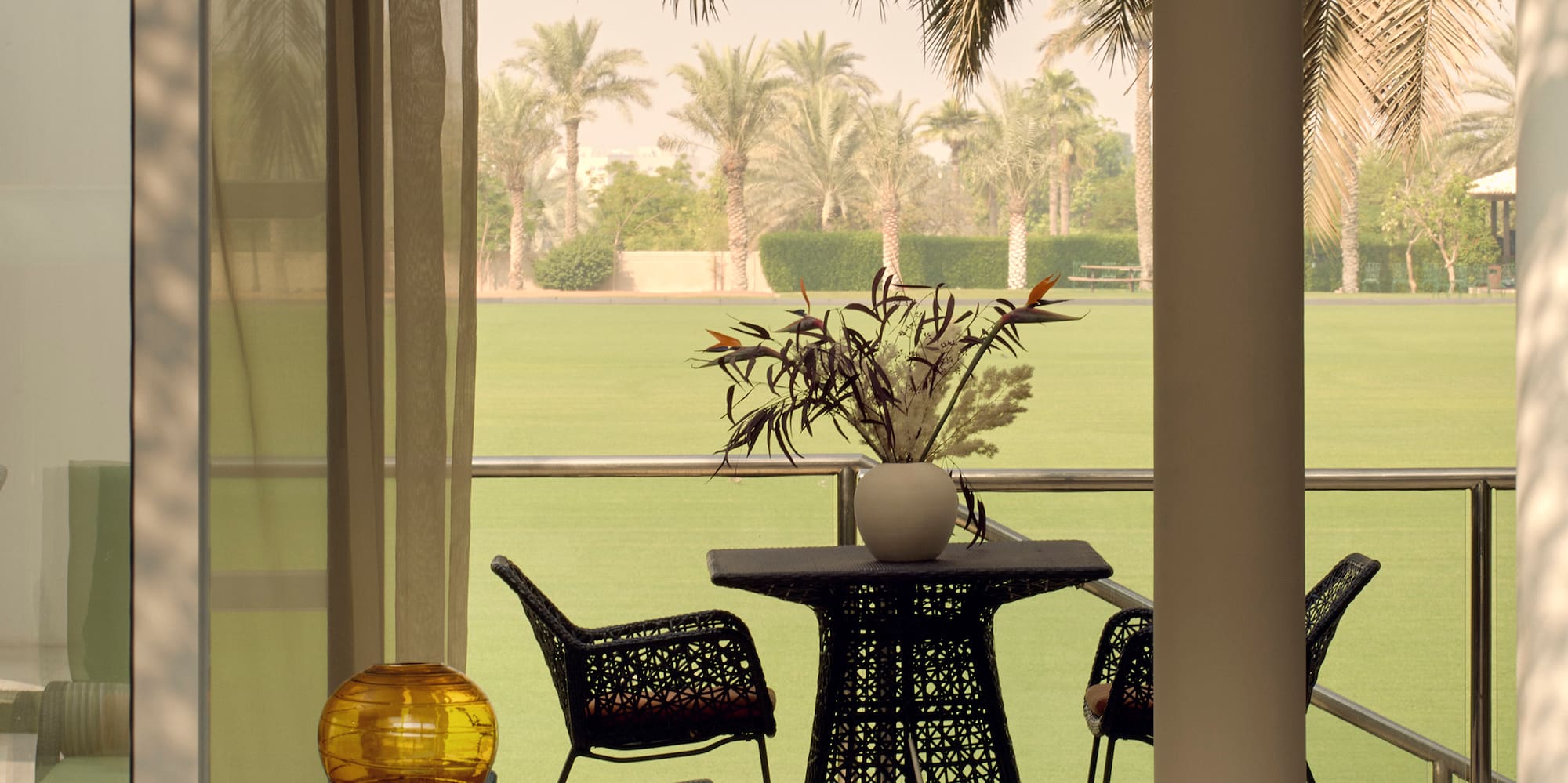 a room with a table and chairs and a lawn