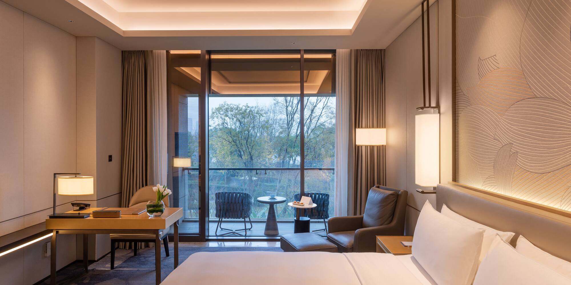 a room with a bed and chairs and a table