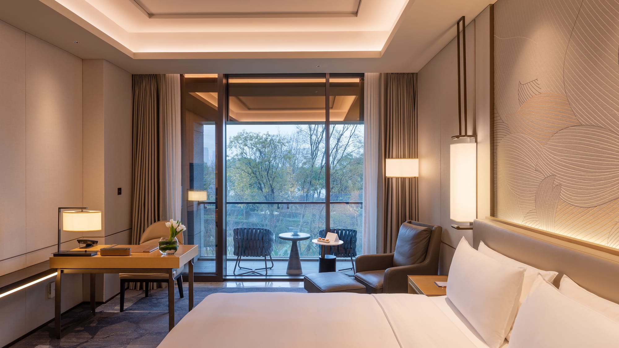 a room with a bed and chairs and a table