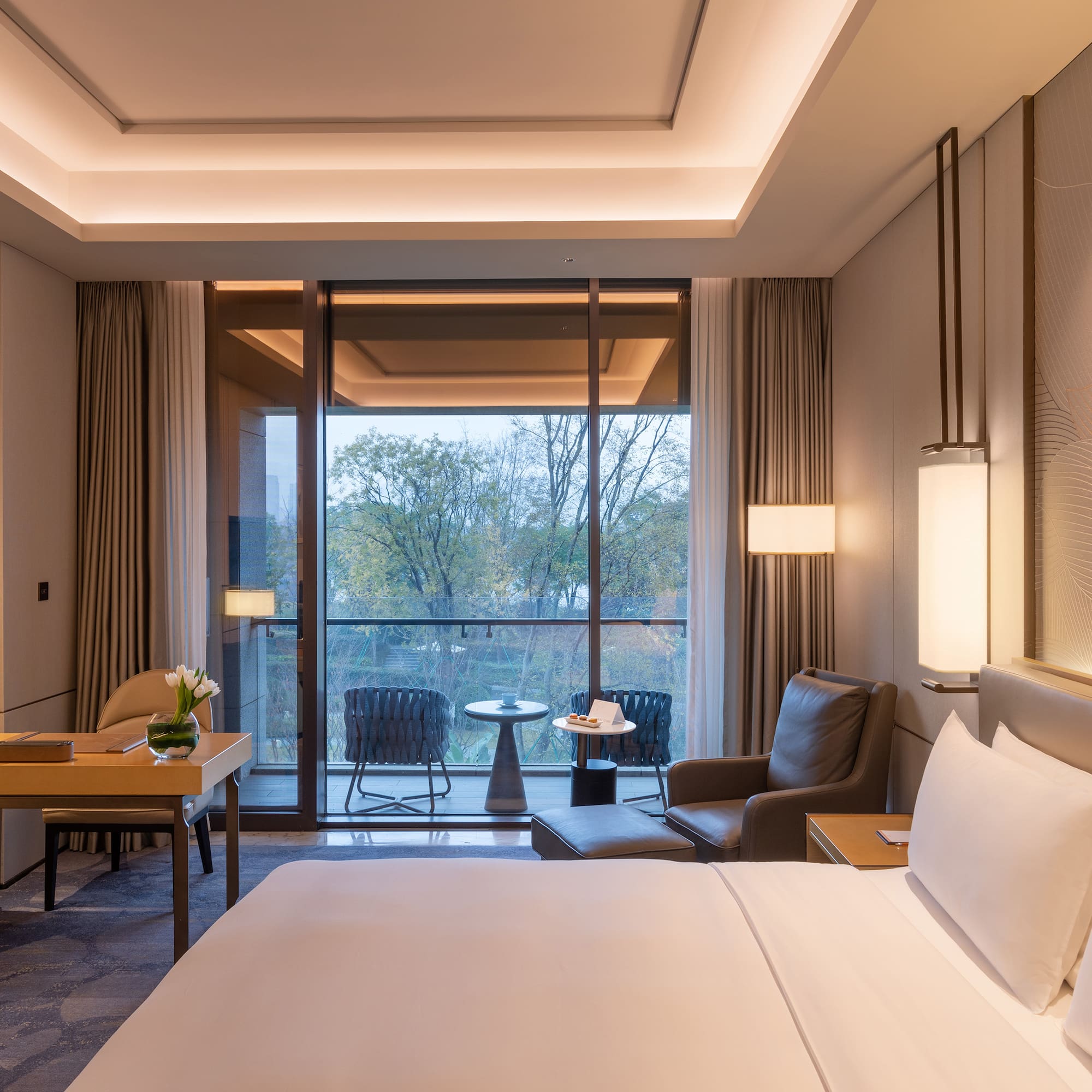 a room with a bed and chairs and a table