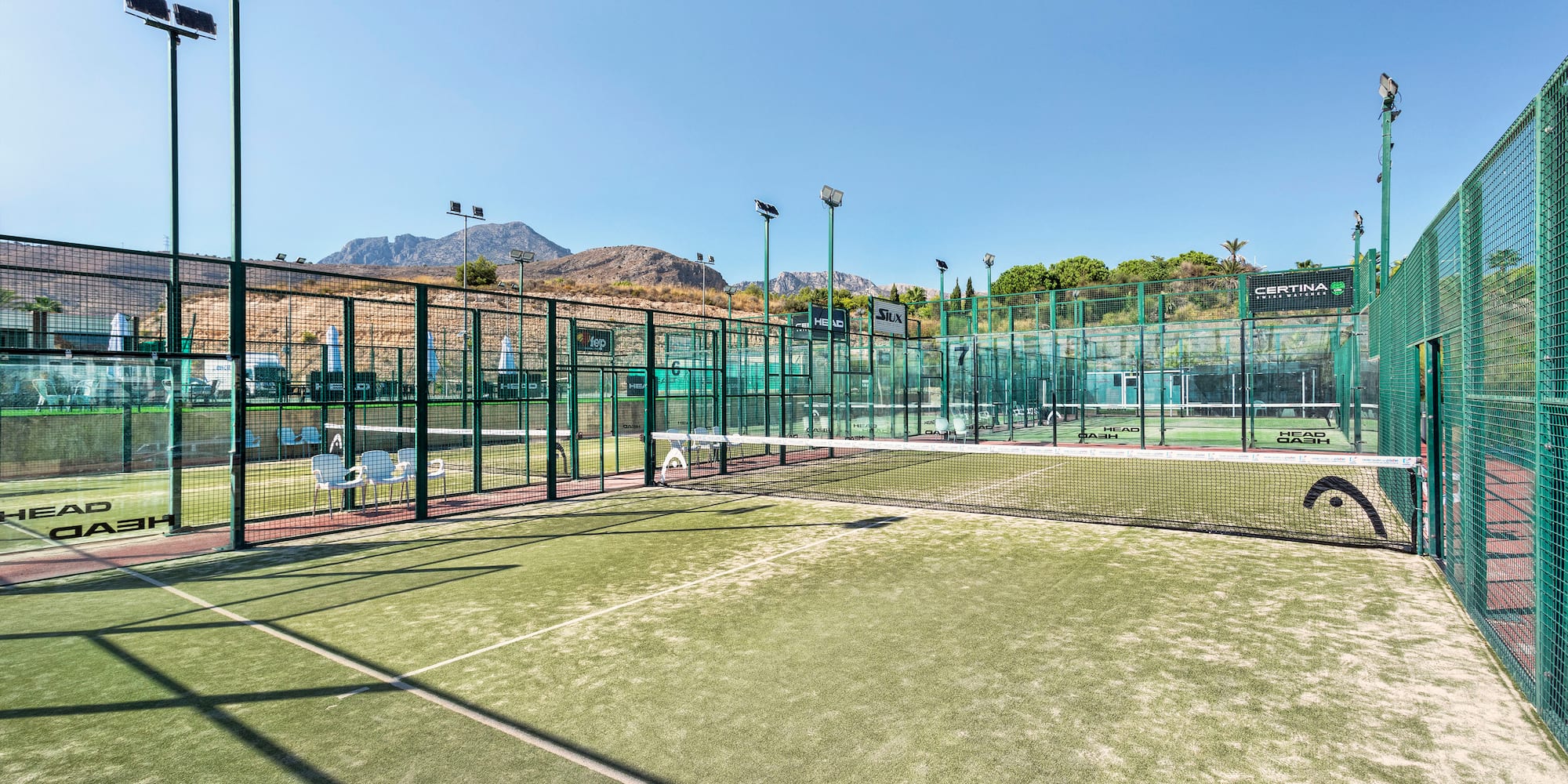 a tennis court with a fenced area
