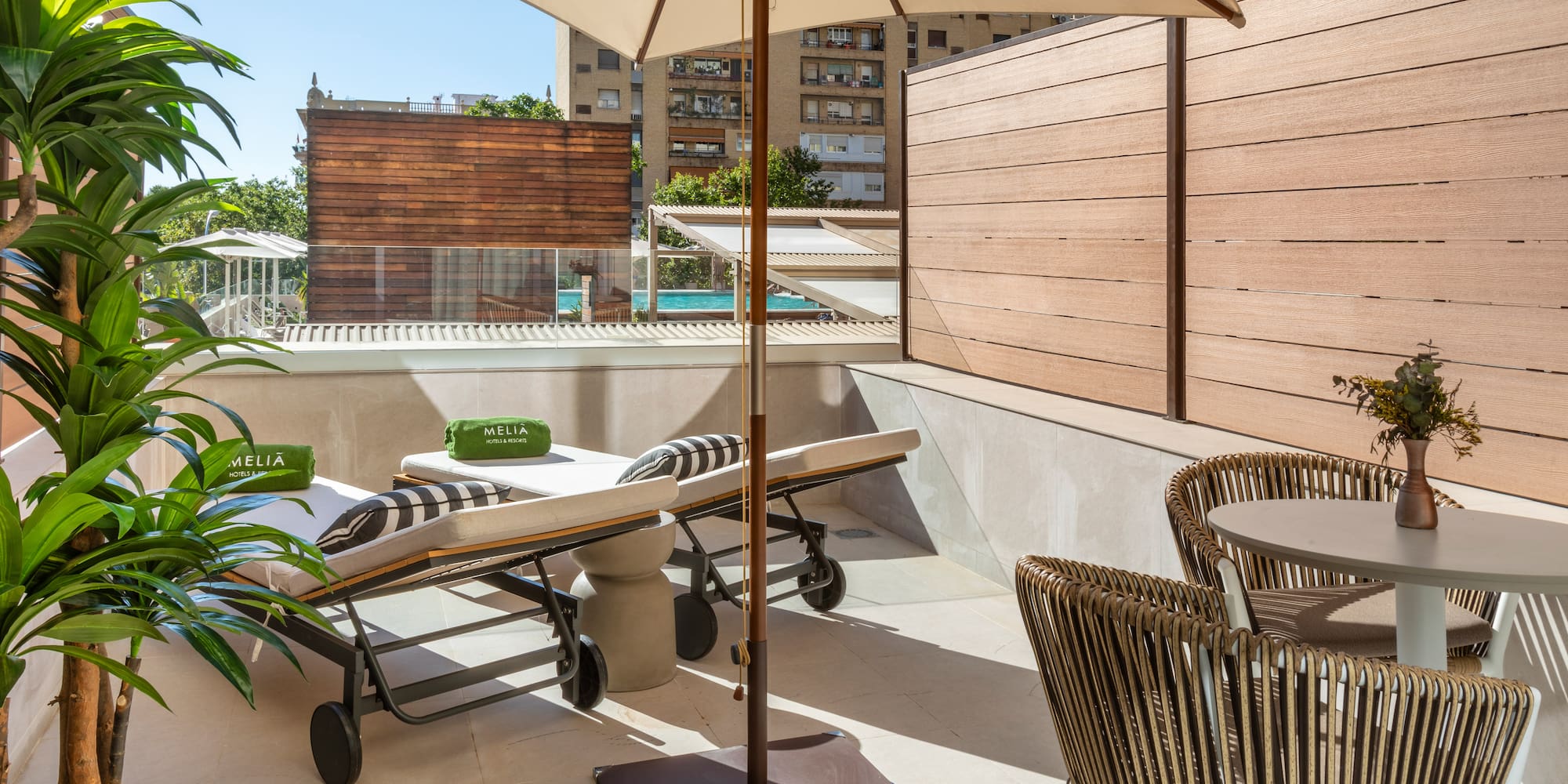 a patio with chairs and umbrellas