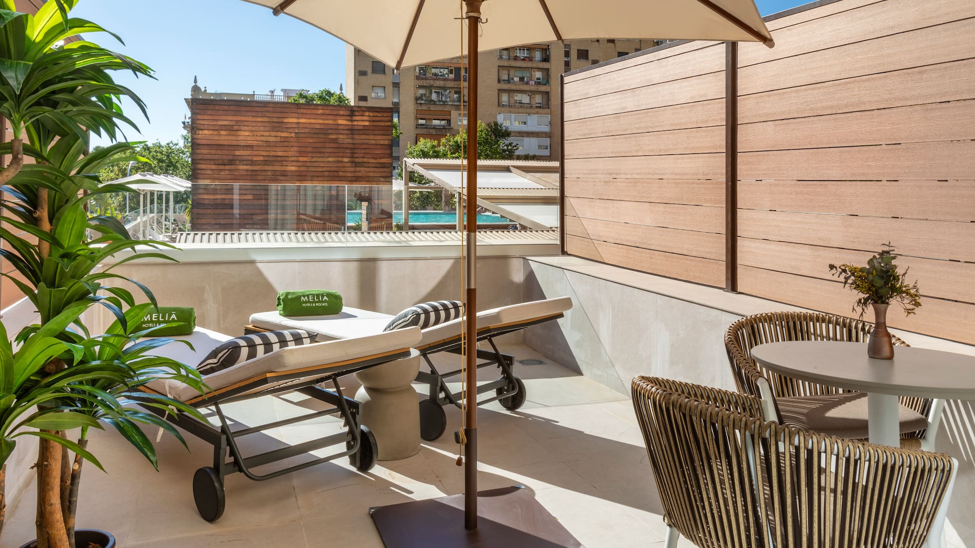 a patio with chairs and umbrellas