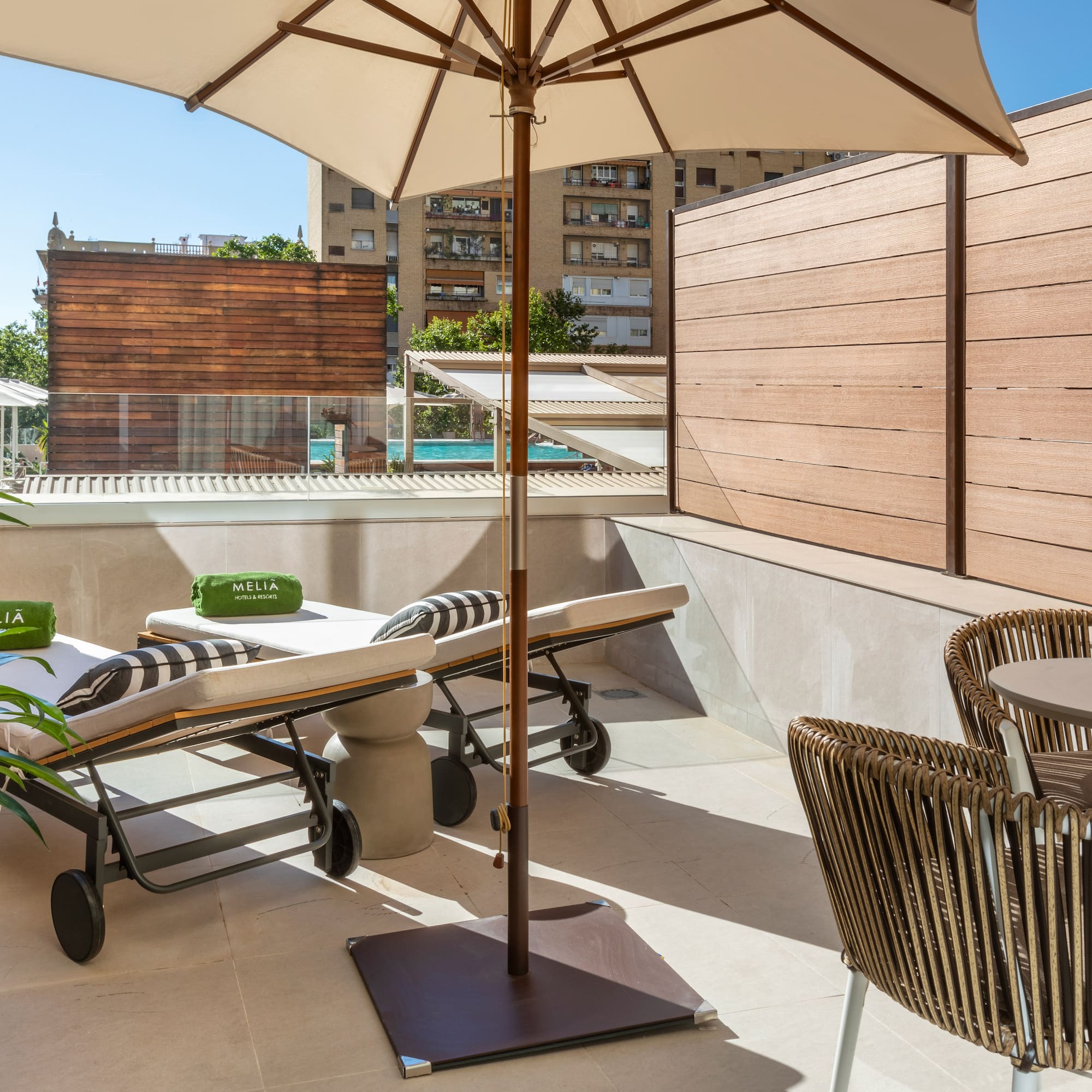 a patio with chairs and umbrellas
