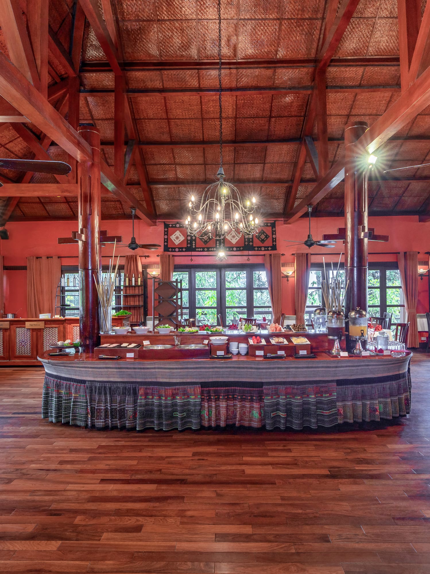 a large room with a large round table and ceiling fans