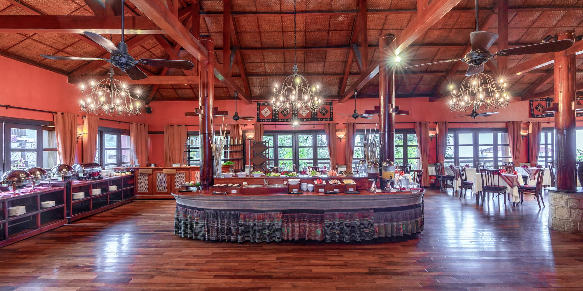 a large room with a large round table and ceiling fans