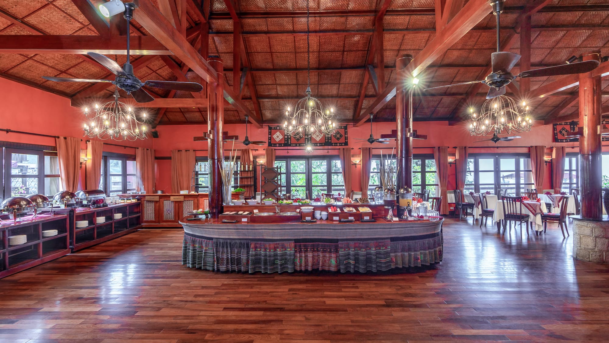 a large room with a large round table and ceiling fans