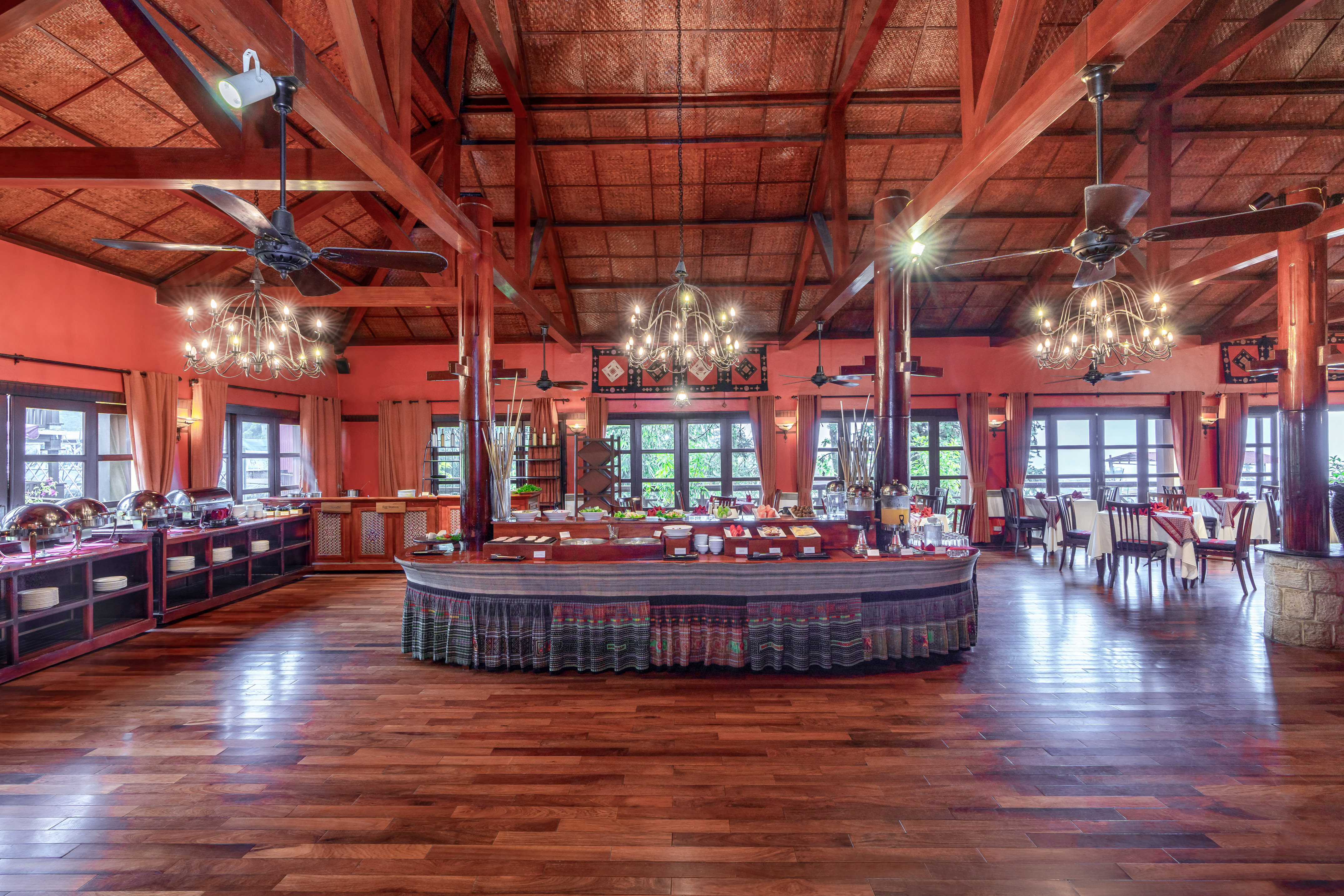 a large room with a large round table and ceiling fans
