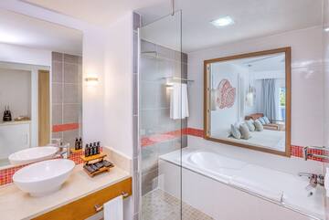 a bathroom with a glass shower and a bathtub