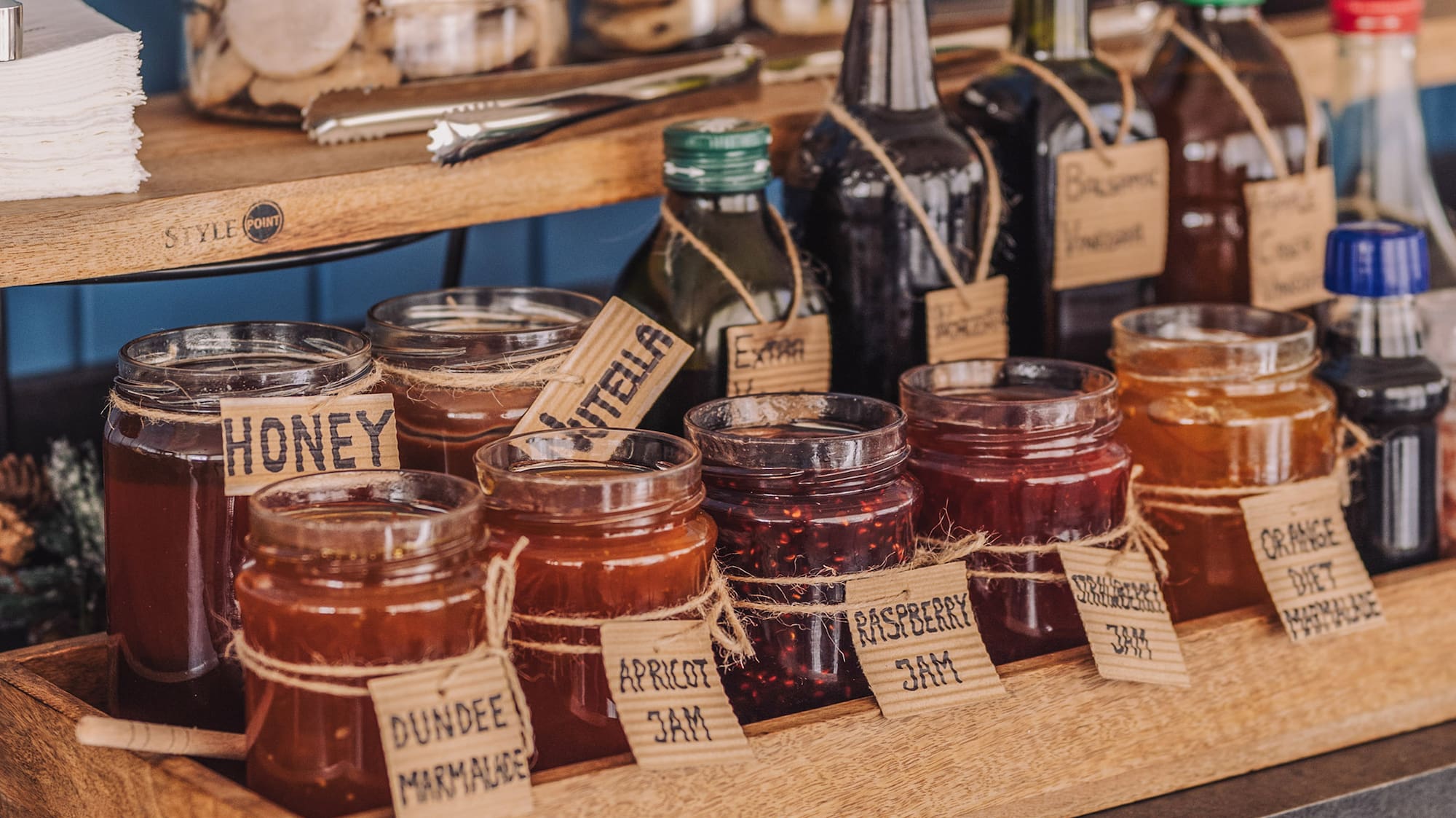 a shelf with jars of jam and other food