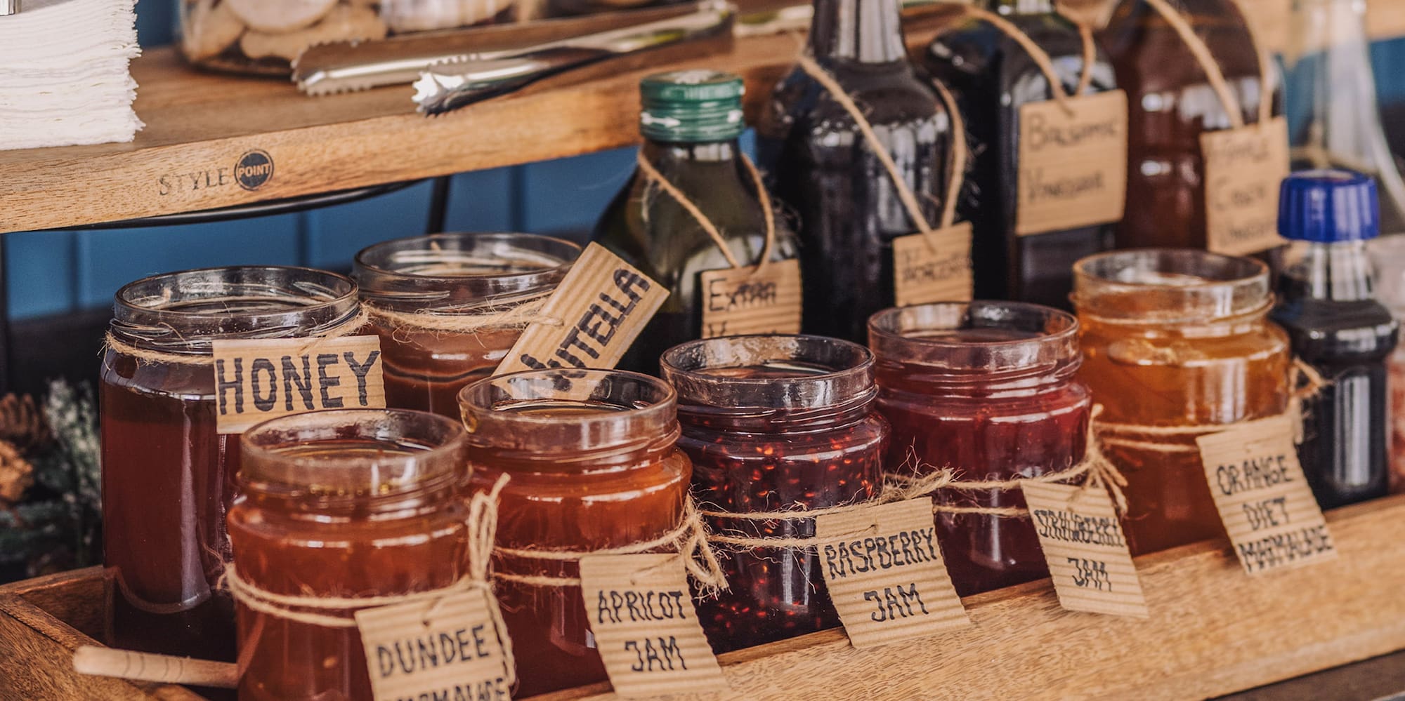 a shelf with jars of jam and other food