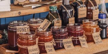 a shelf with jars of jam and other food