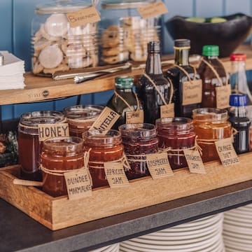 a shelf with jars of jam and other food