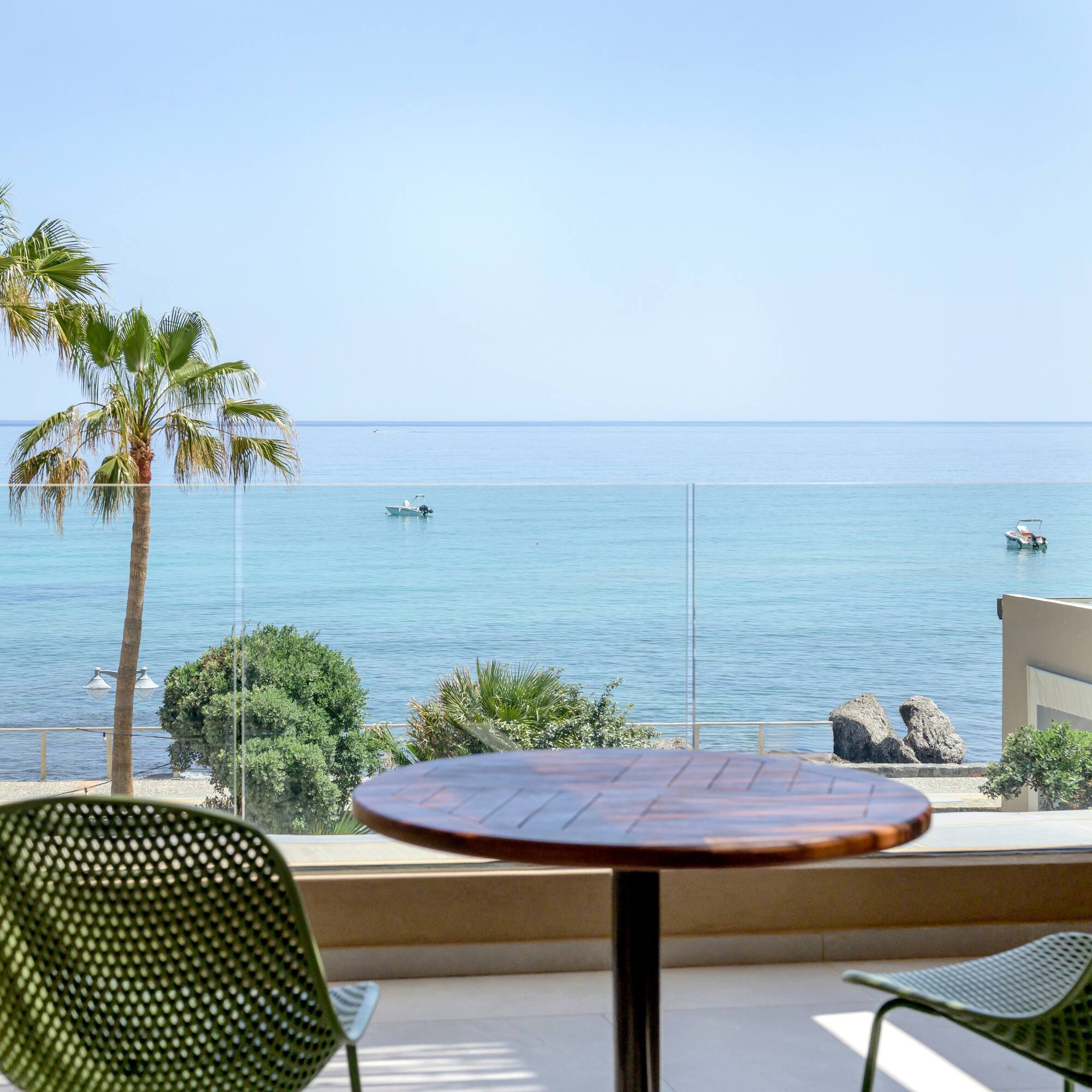 a table and chairs overlooking a body of water.