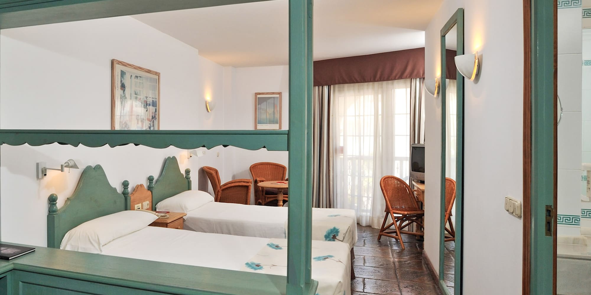 a room with two beds and a table