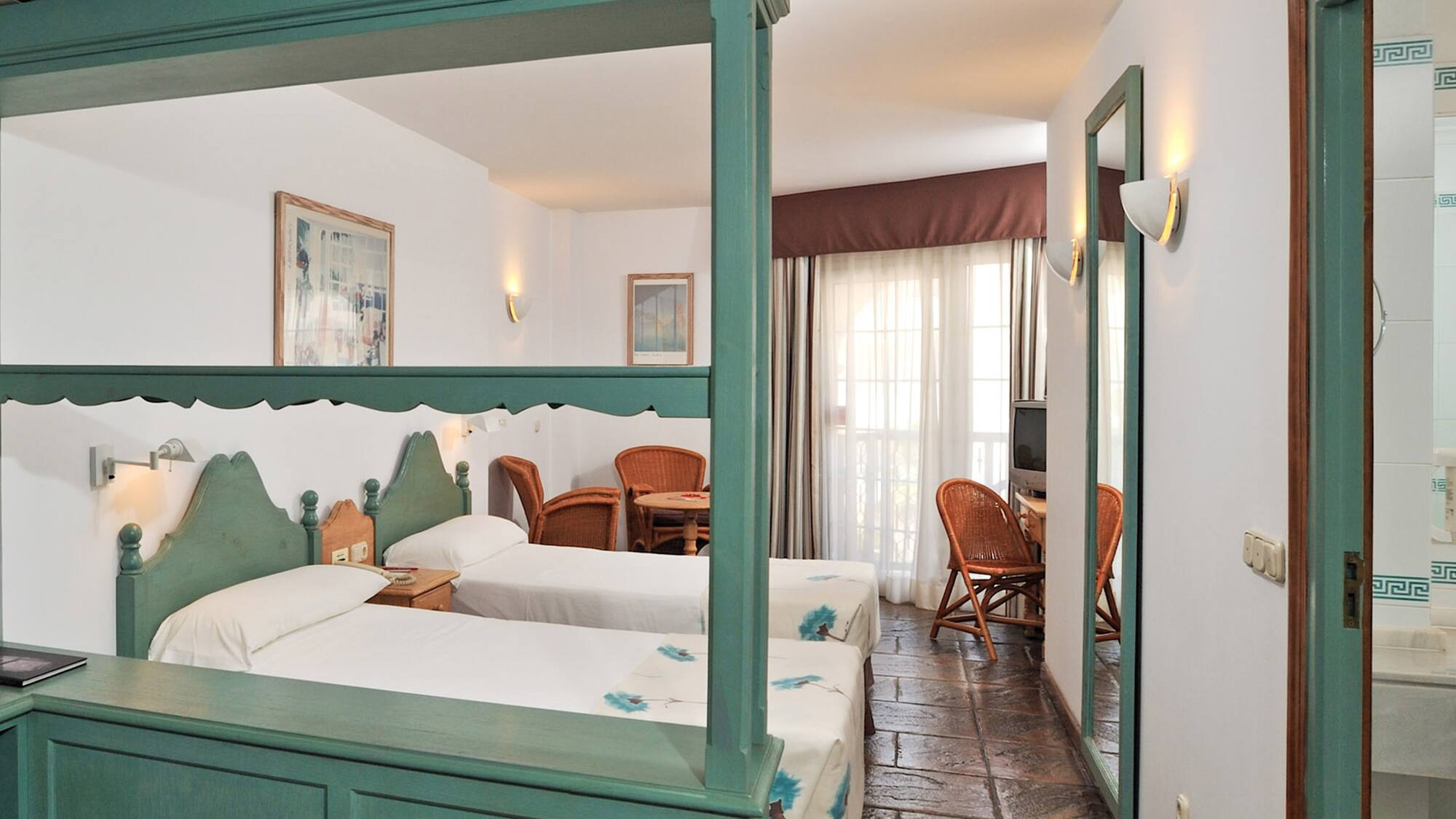 a room with two beds and a table