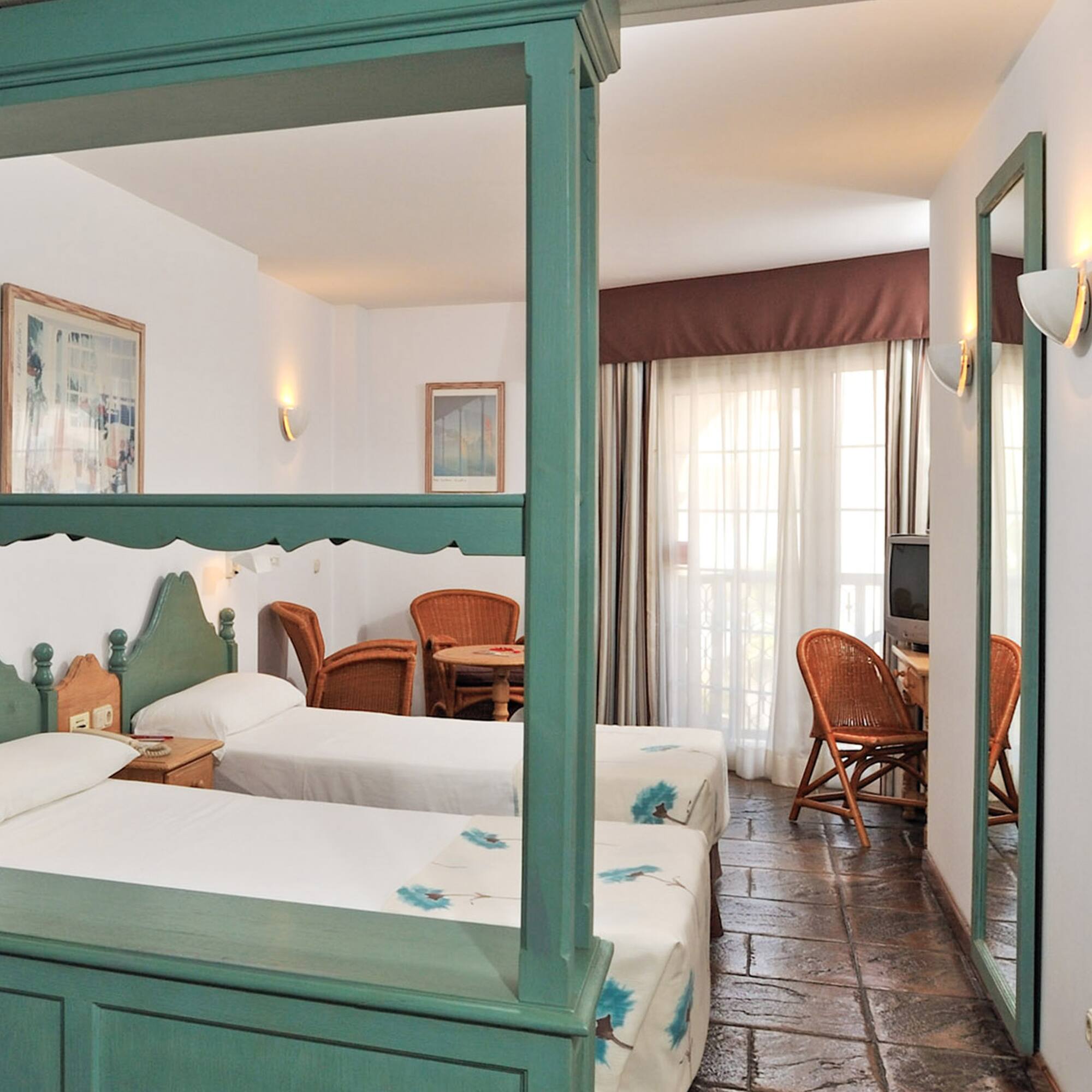 a room with two beds and a table