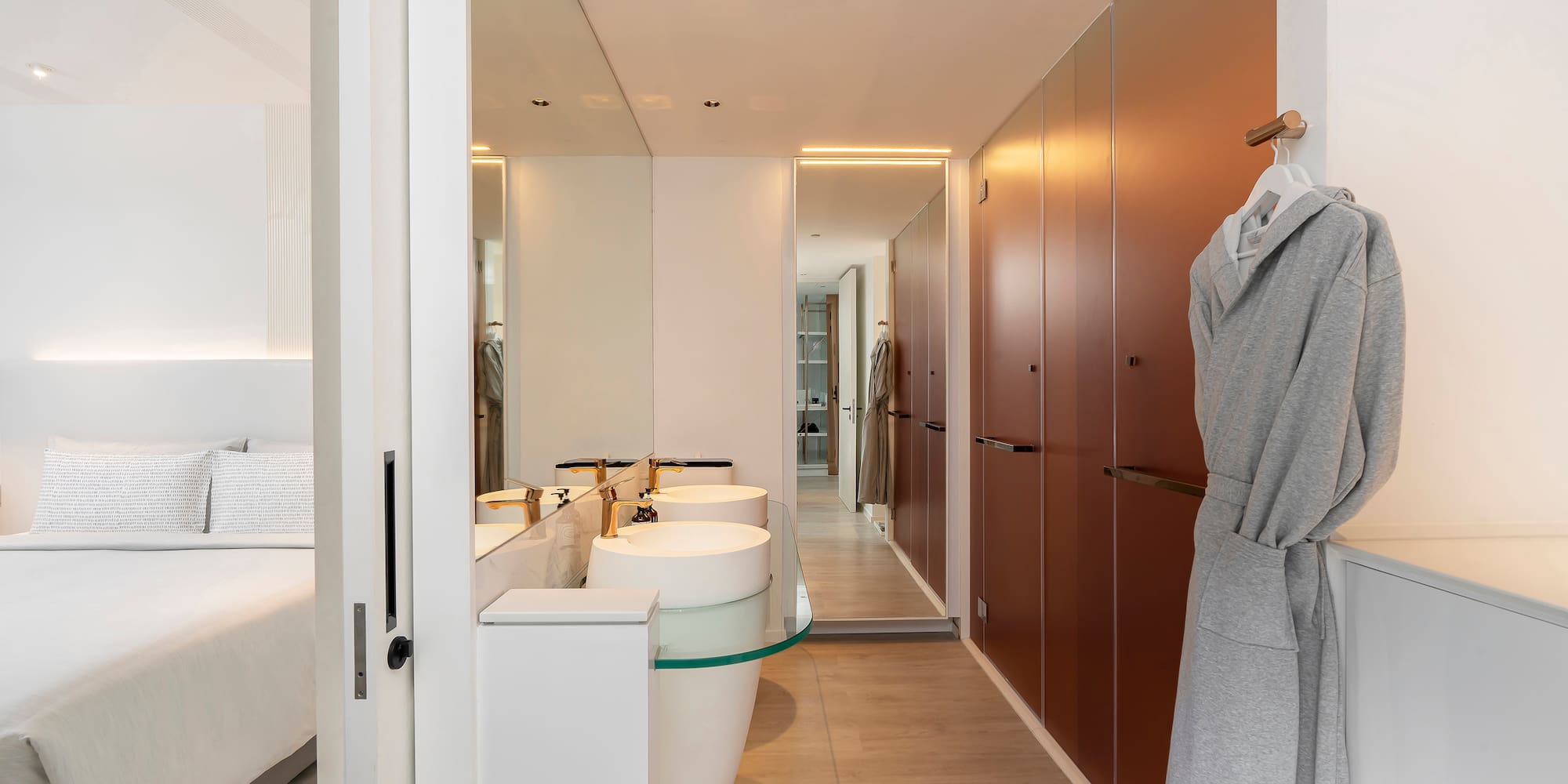 a bathroom with a bathrobe and sink