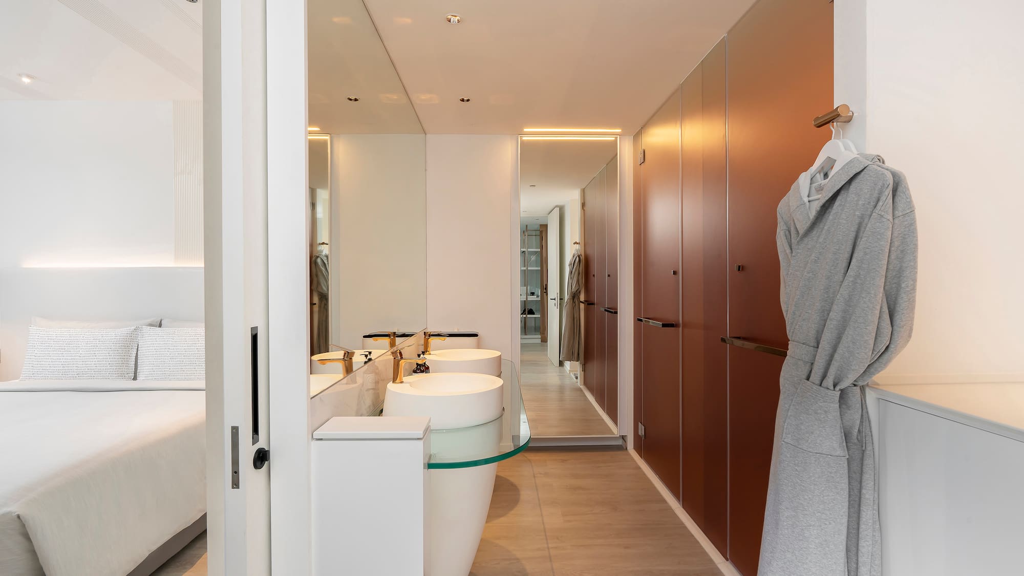 a bathroom with a bathrobe and sink