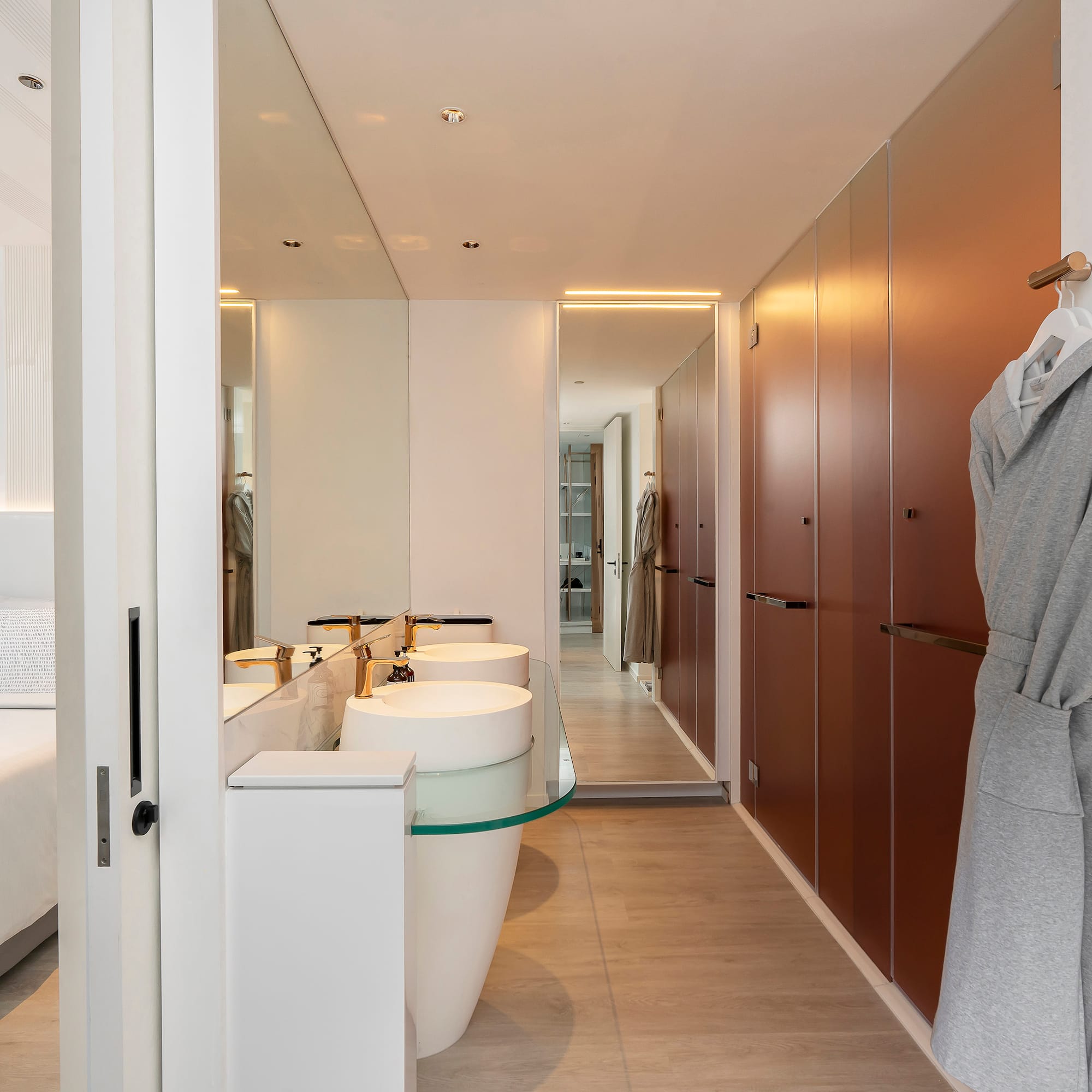 a bathroom with a bathrobe and sink