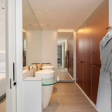 a bathroom with a bathrobe and sink
